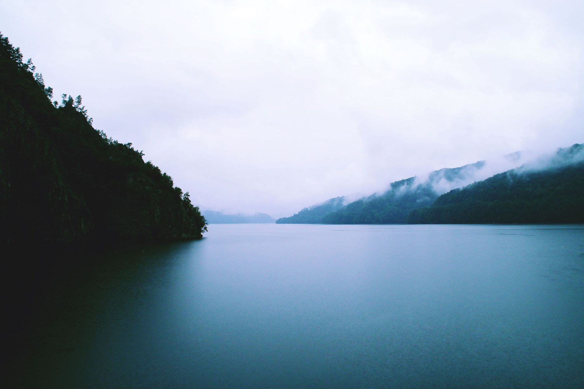 A deep lake on a cloudy day.