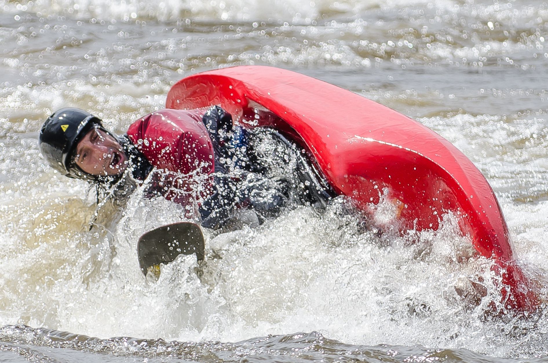 A kayaker doing an eskimo roll.