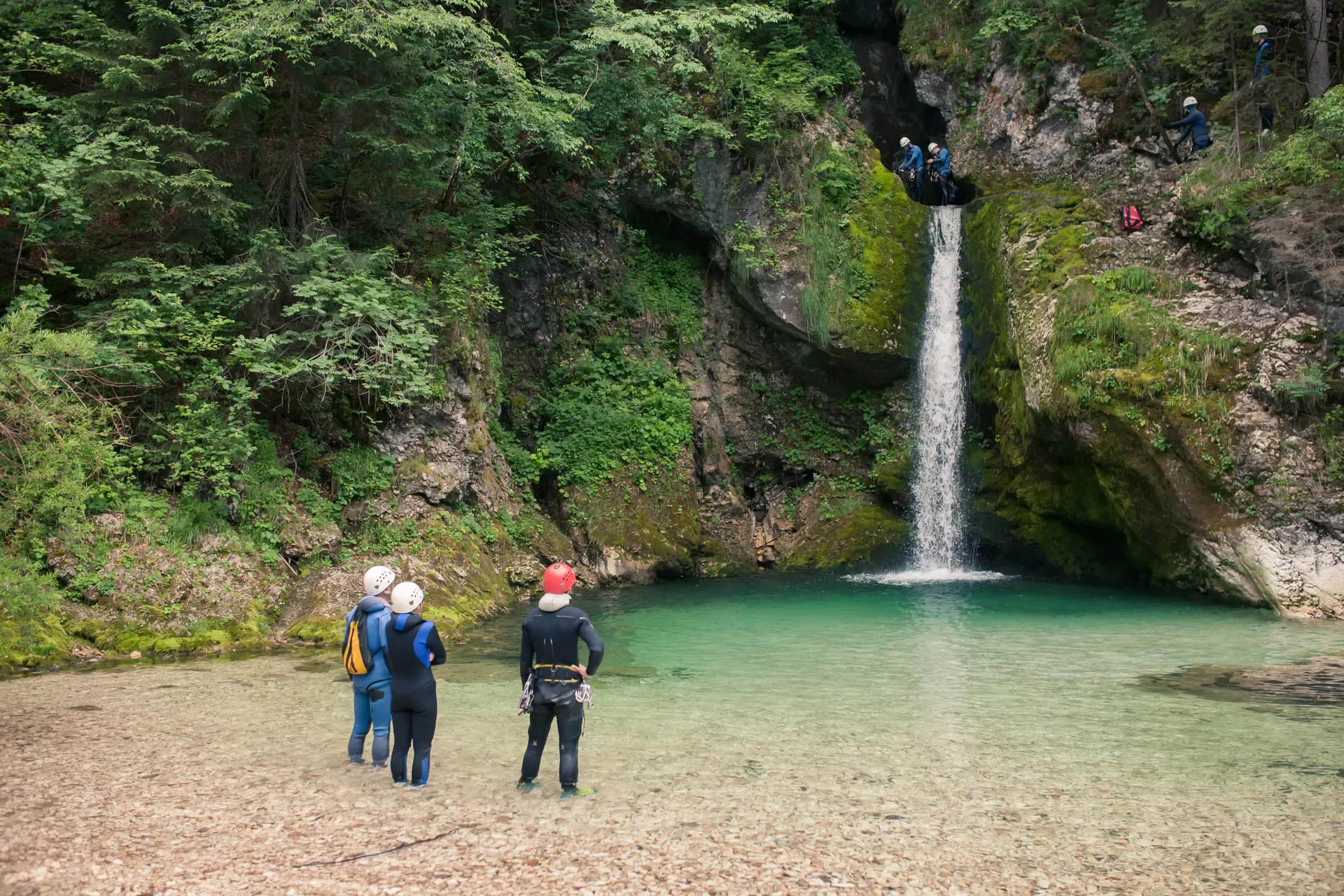 Canyoners at a waterfall in the Triglav National Park, Slovenia