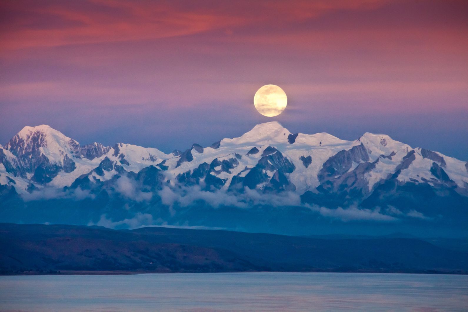 The full moon rising behind the Ancohuma mountain. The highest Peaks are Illampu 6368m, left, and Ancohuma, 6427m, right. 