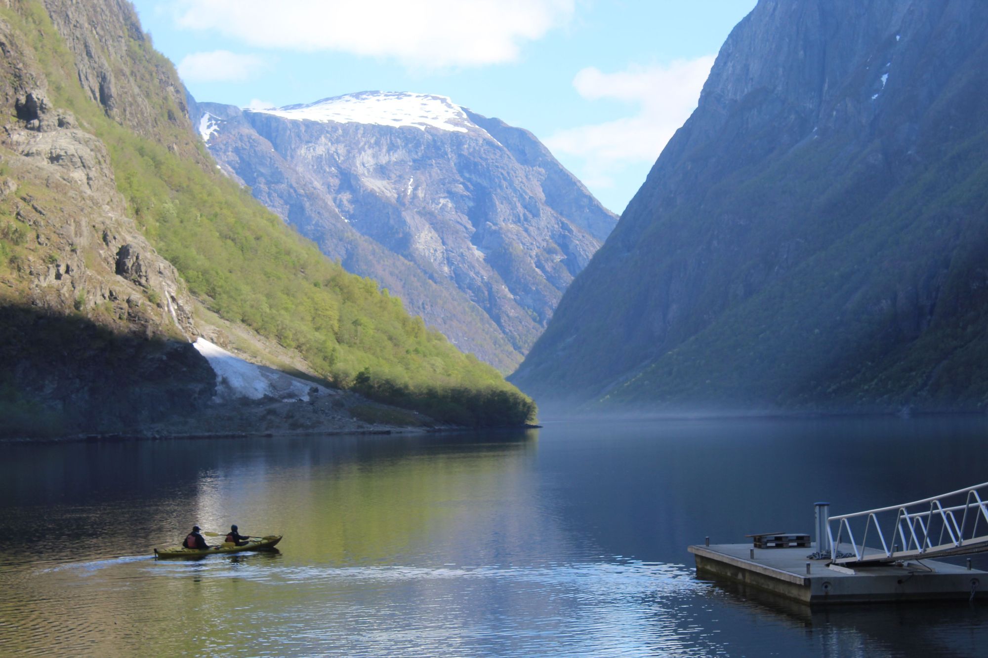 A kayak wanders the fjord in summer. In winter, the fjord can freeze over completely. 
