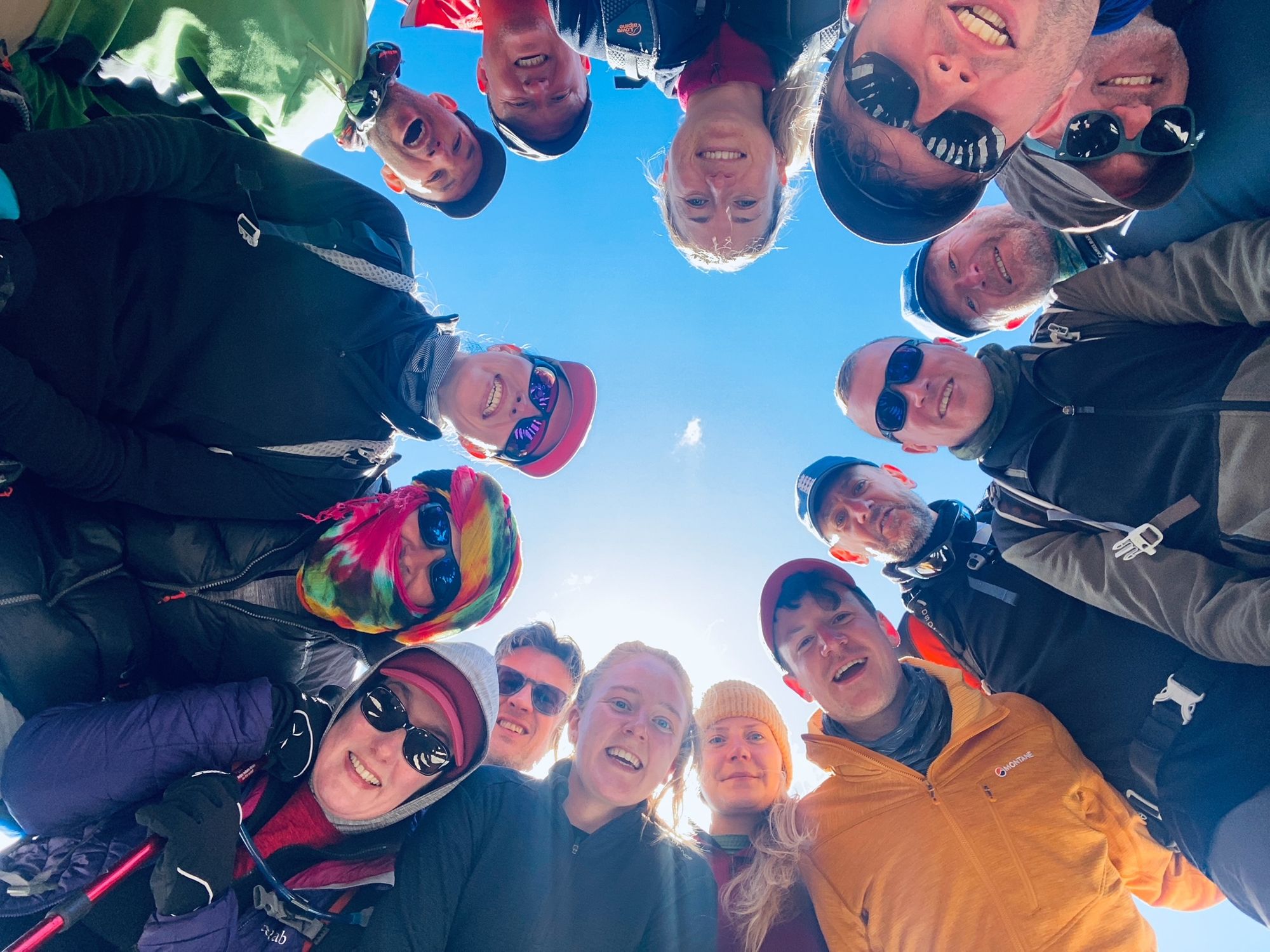 A group of Much Better Adventurers stood in a circle, looking down at the camera.