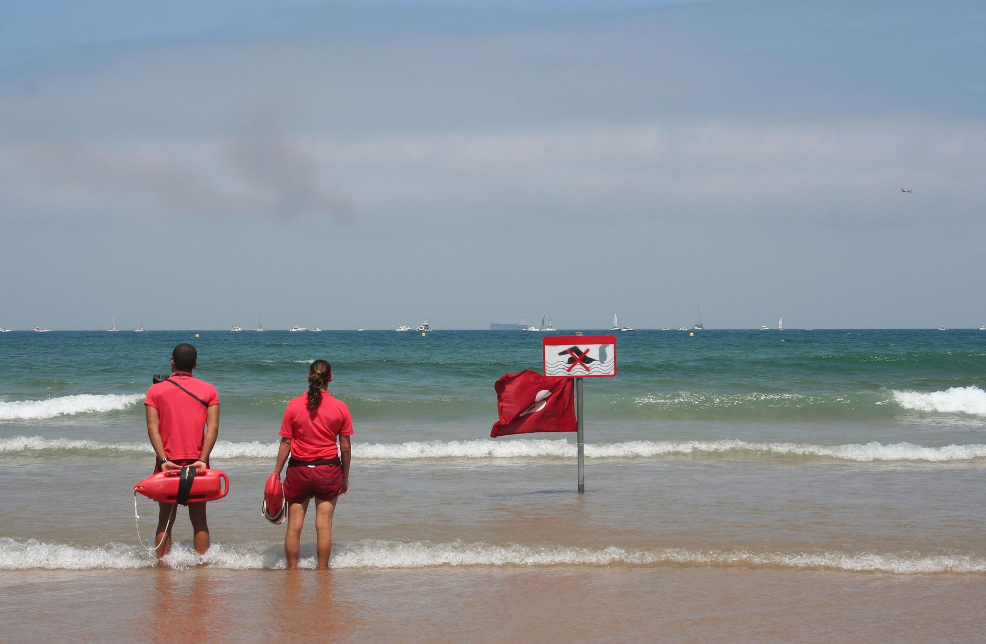Lifeguards standing on a beach.