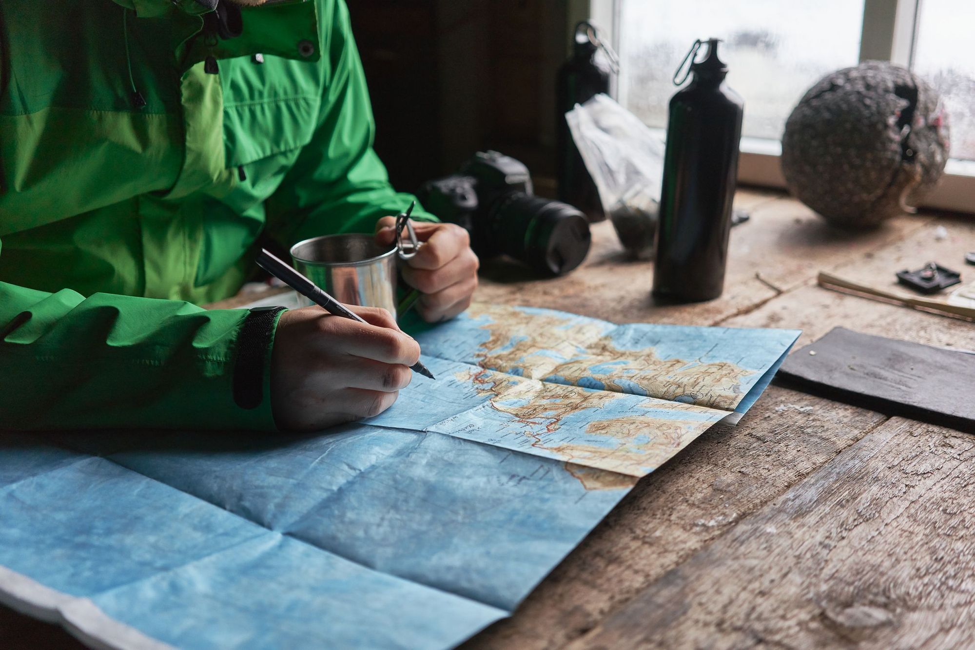 A hiker planning a route in a cabin on the Lofoten Islands.