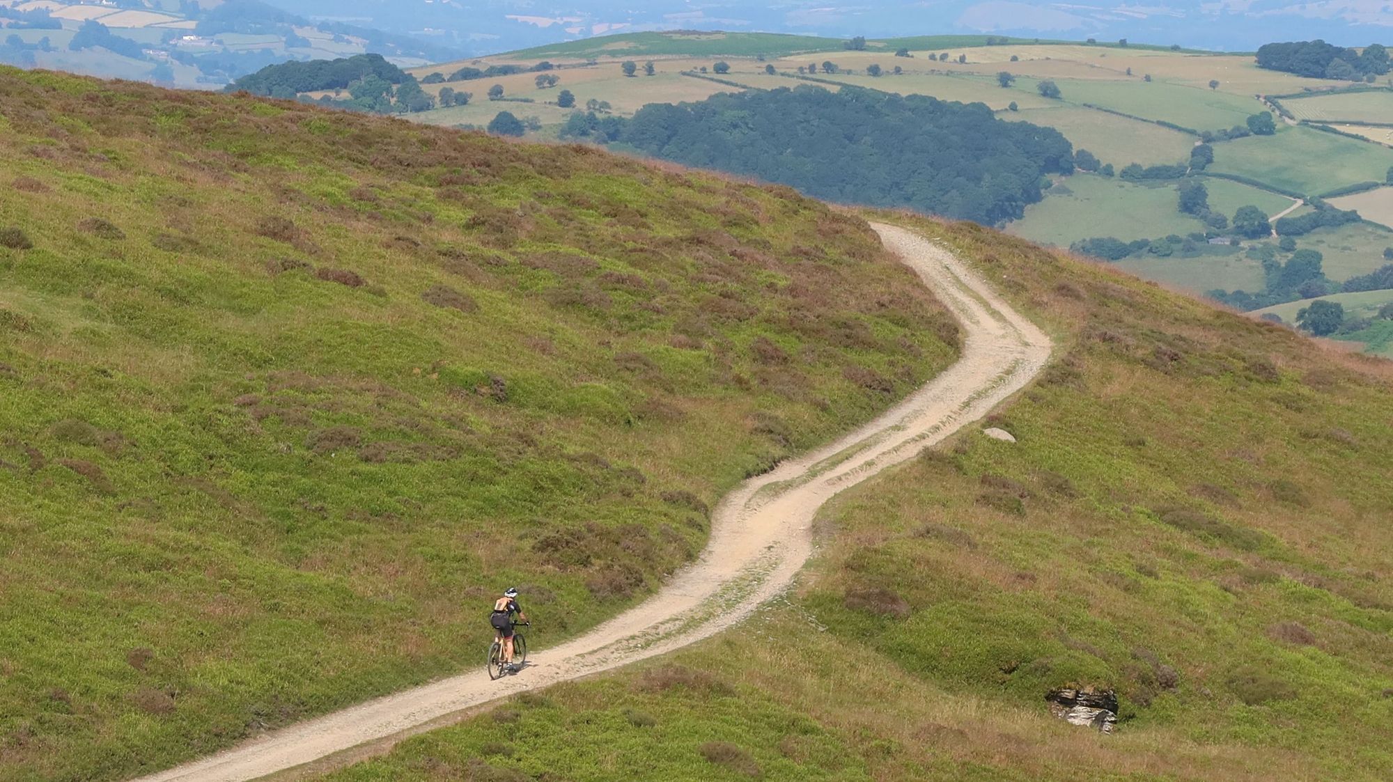 A gravel cyclist climbs up the mountain Twmpa, near the town of Hay-on-Wye in Wales.