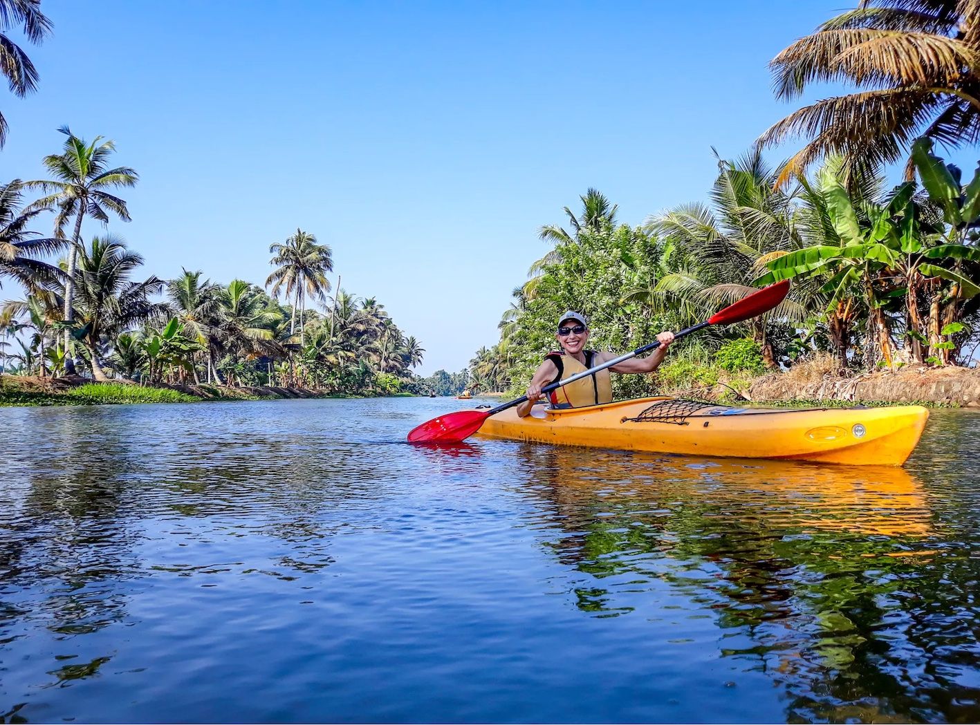 A woman kayaking in the Kerala backwaters.