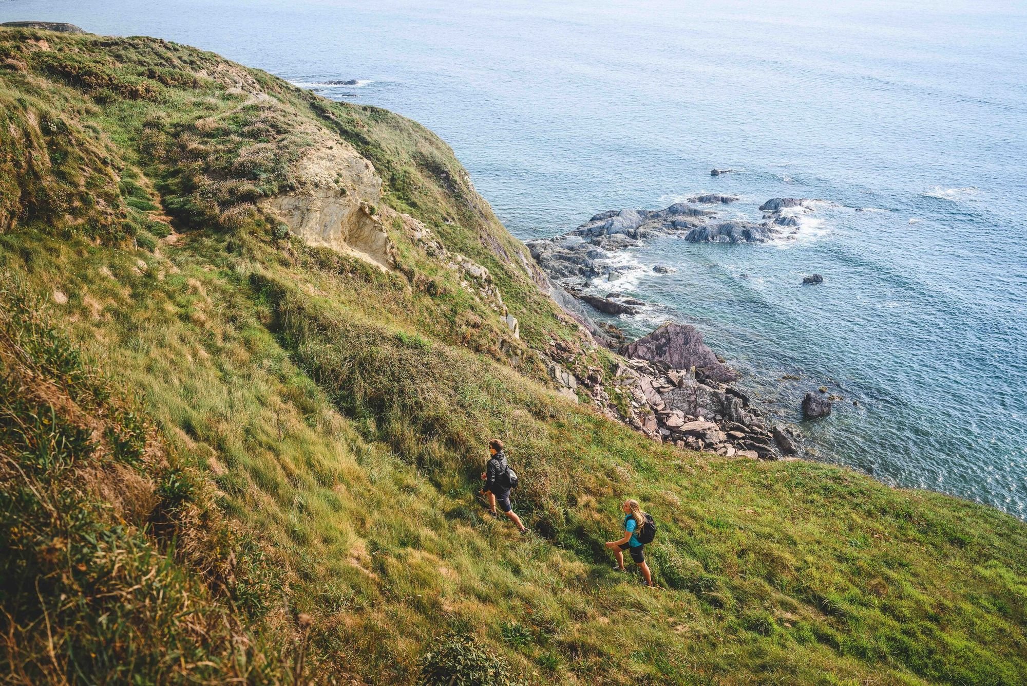 Two hikers on the coastal path.