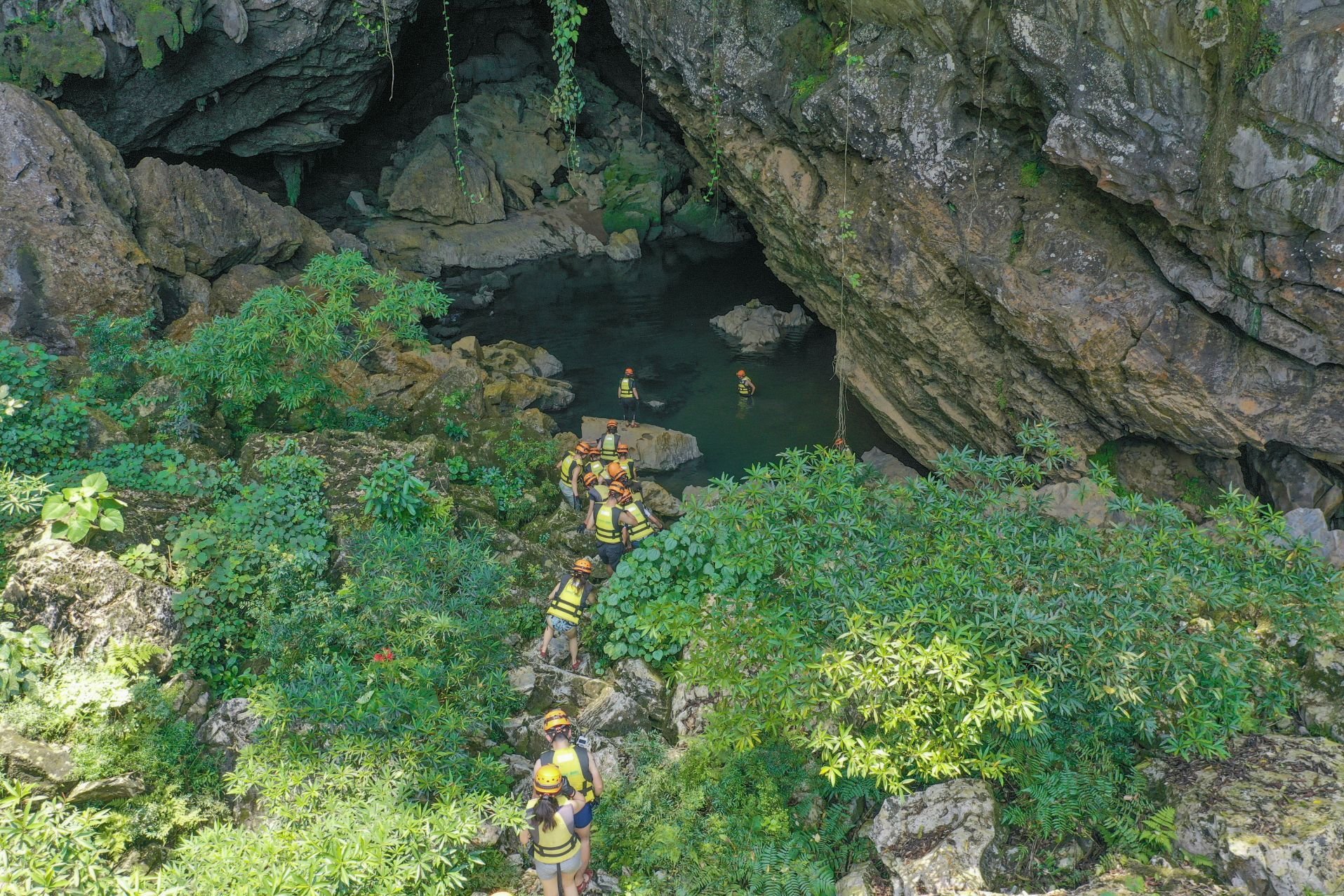 A group descends into Tra Ang cave on a caving expedition in the Phong Nha-Kẻ Bàng national park.