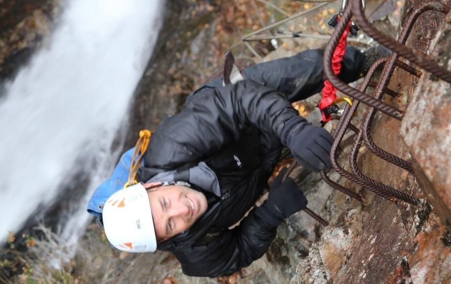 A man climbing the only via ferrata in Scotland, near Kinlochleven.