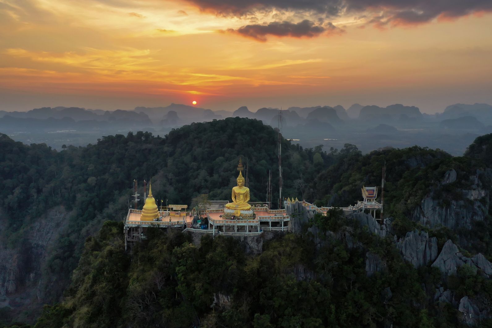 The sun sets over the remarkable Tiger Cave Temple in Krabi, Thailand