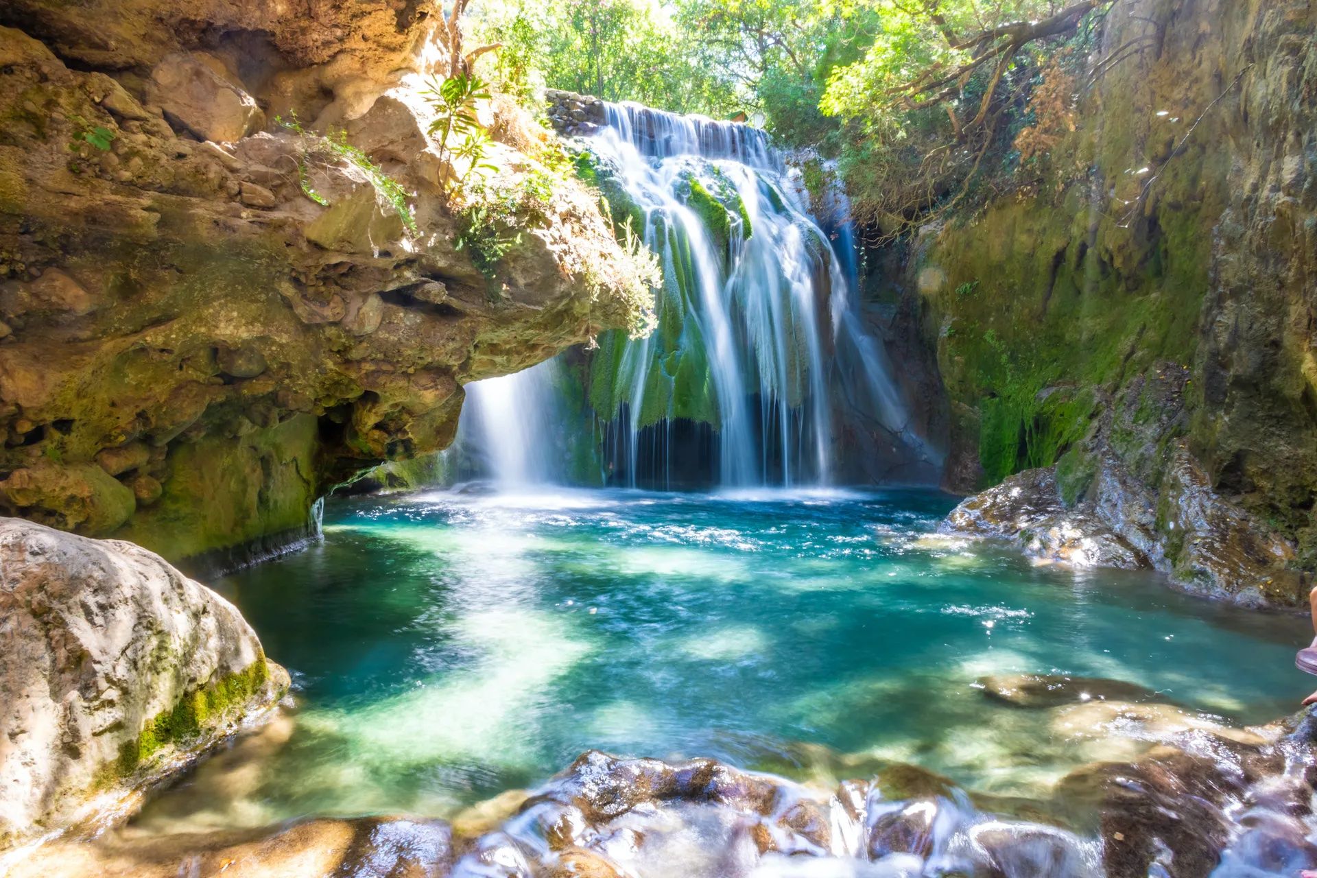 The Akchour waterfall in Morocco, cascading into a clear blue pool.