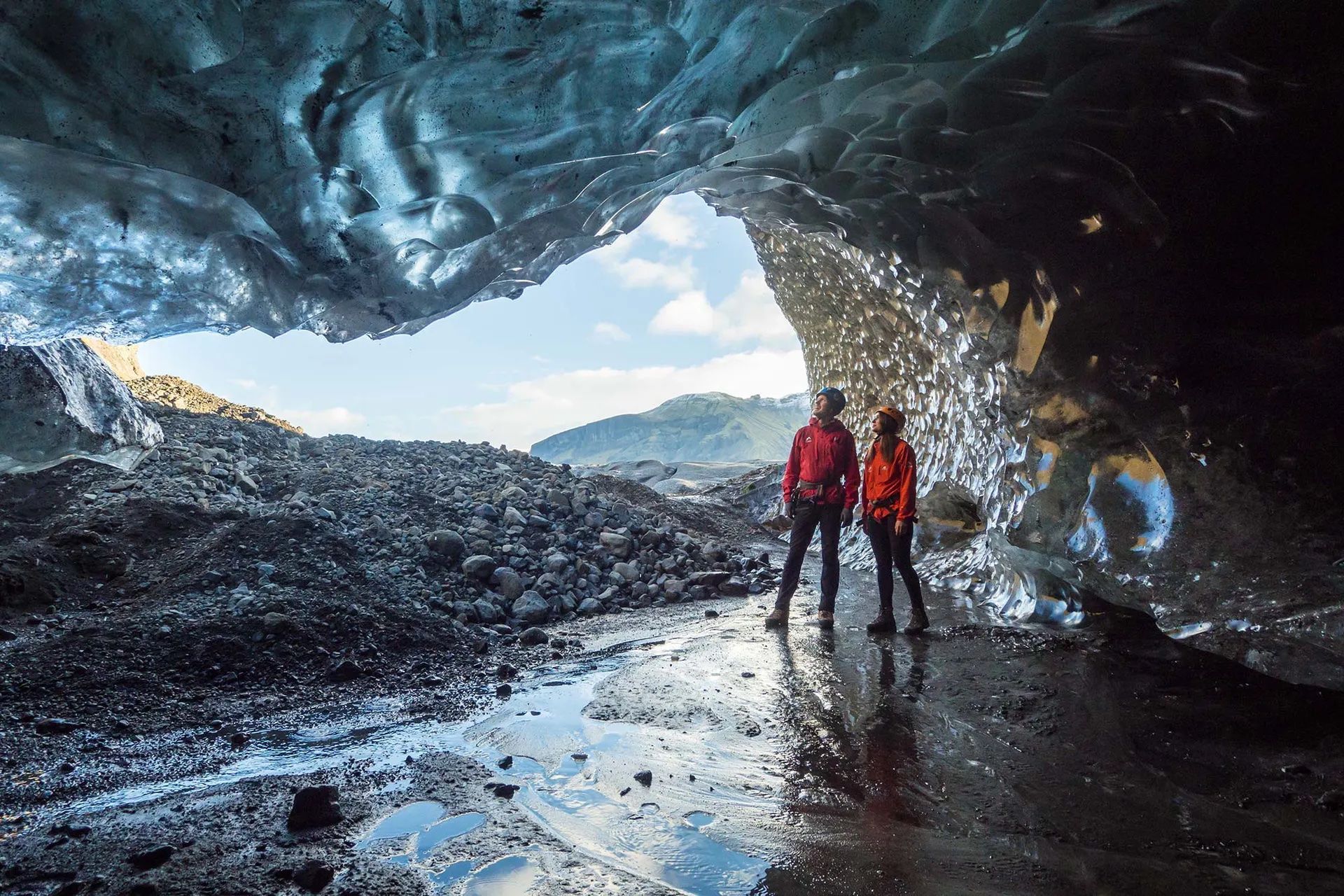 Two tourists inside an ice cave in Iceland, on a Much Better Adventures trip