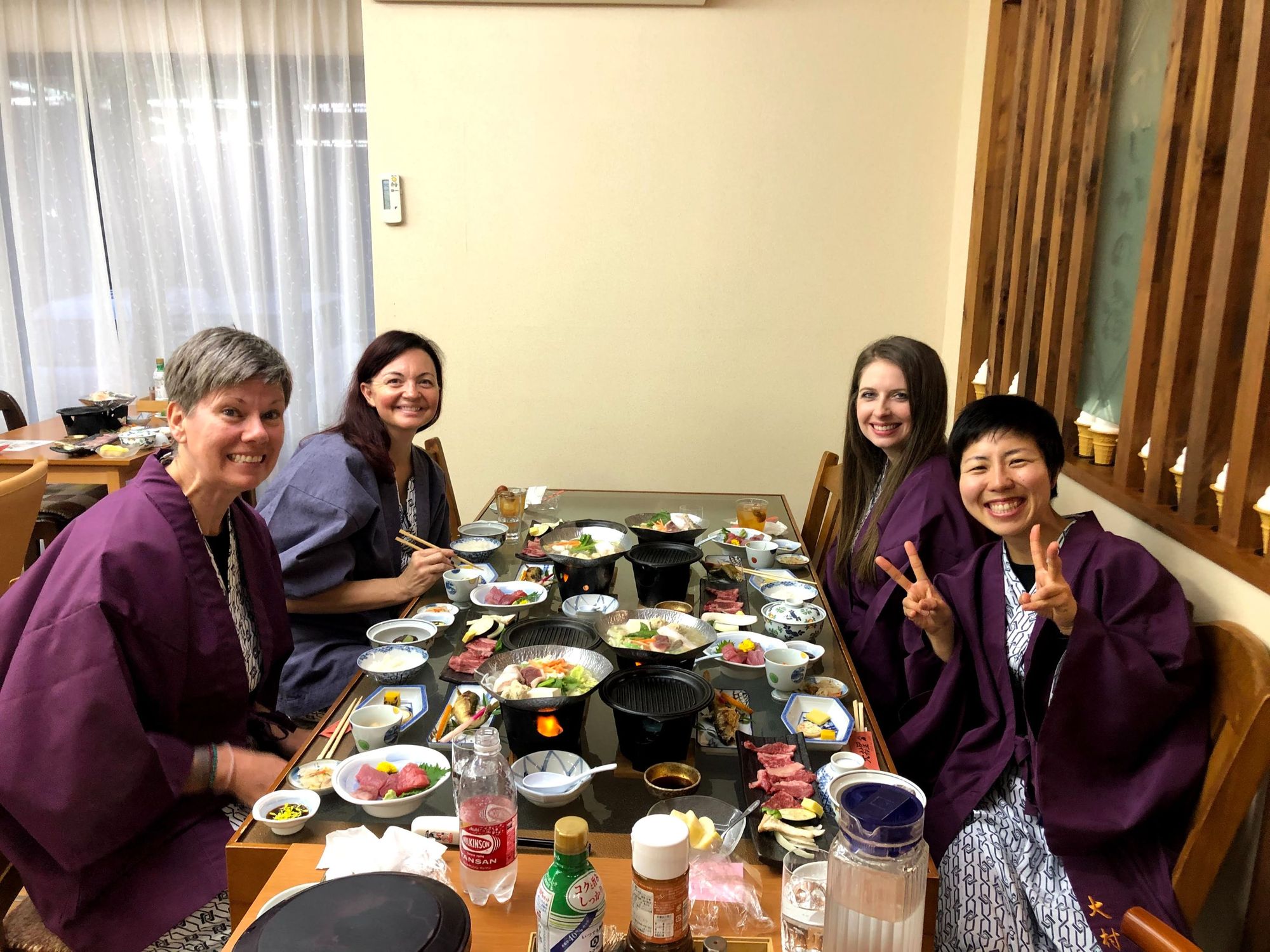 A group enjoying a meal at a traditional Ryokan in Japan.
