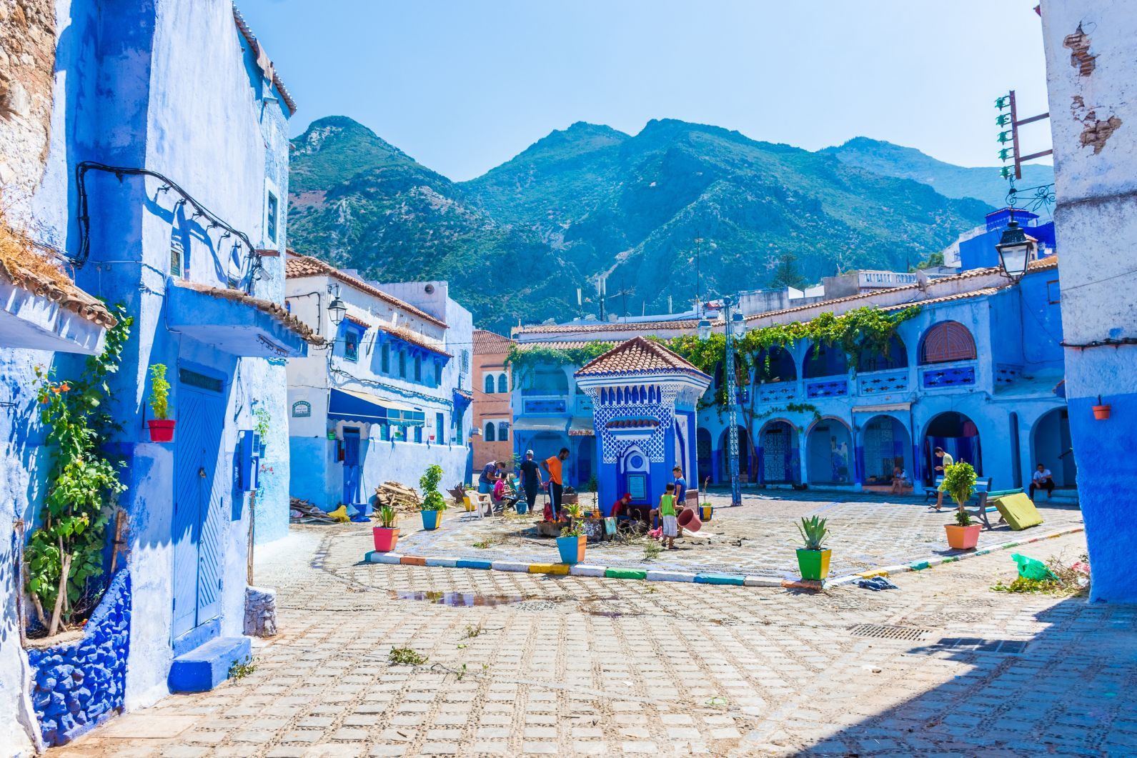 Place Outa el Hammam, the main open square in Chefchaouen, with the backdrop of the mountains behind. Photo: Getty