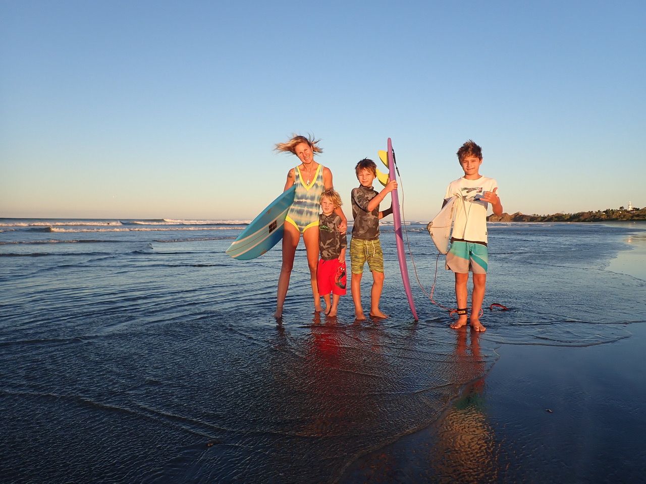 Surfer Hayley Lawrence poses with her three children.