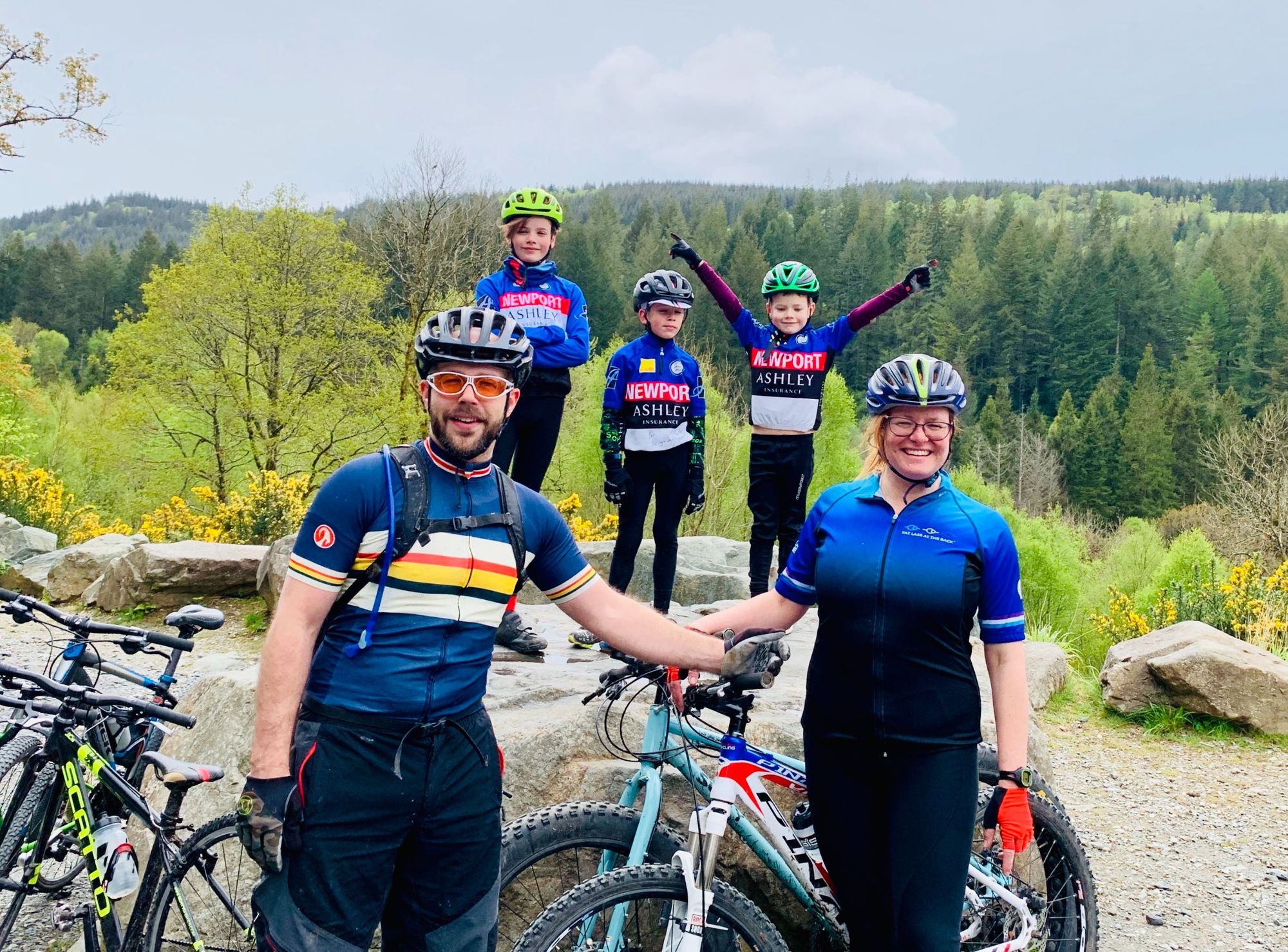 A couple pose with their three children while out on a cycling trip.