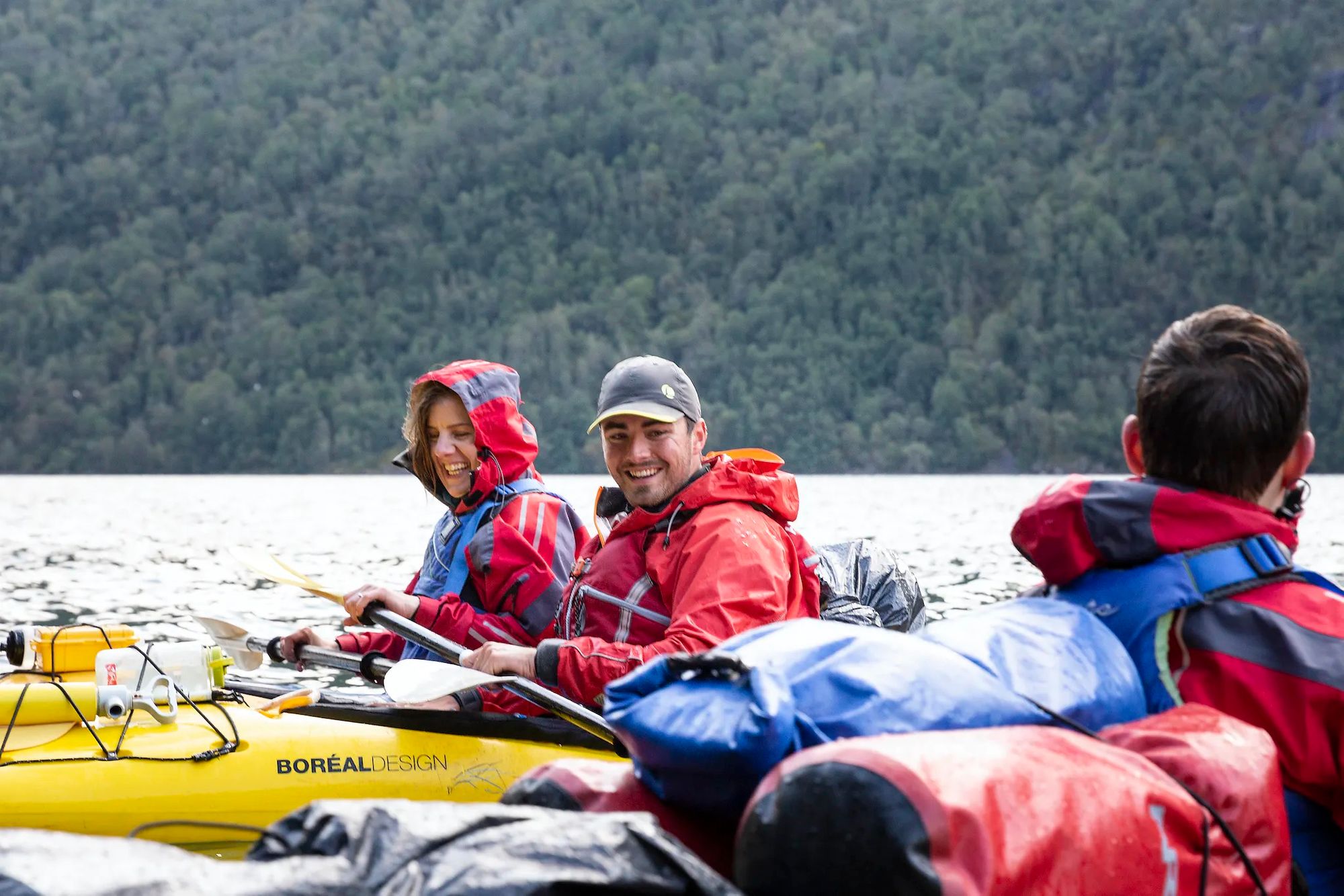Three kayakers on a Much Better Adventures trip in the Norwegian fjords.