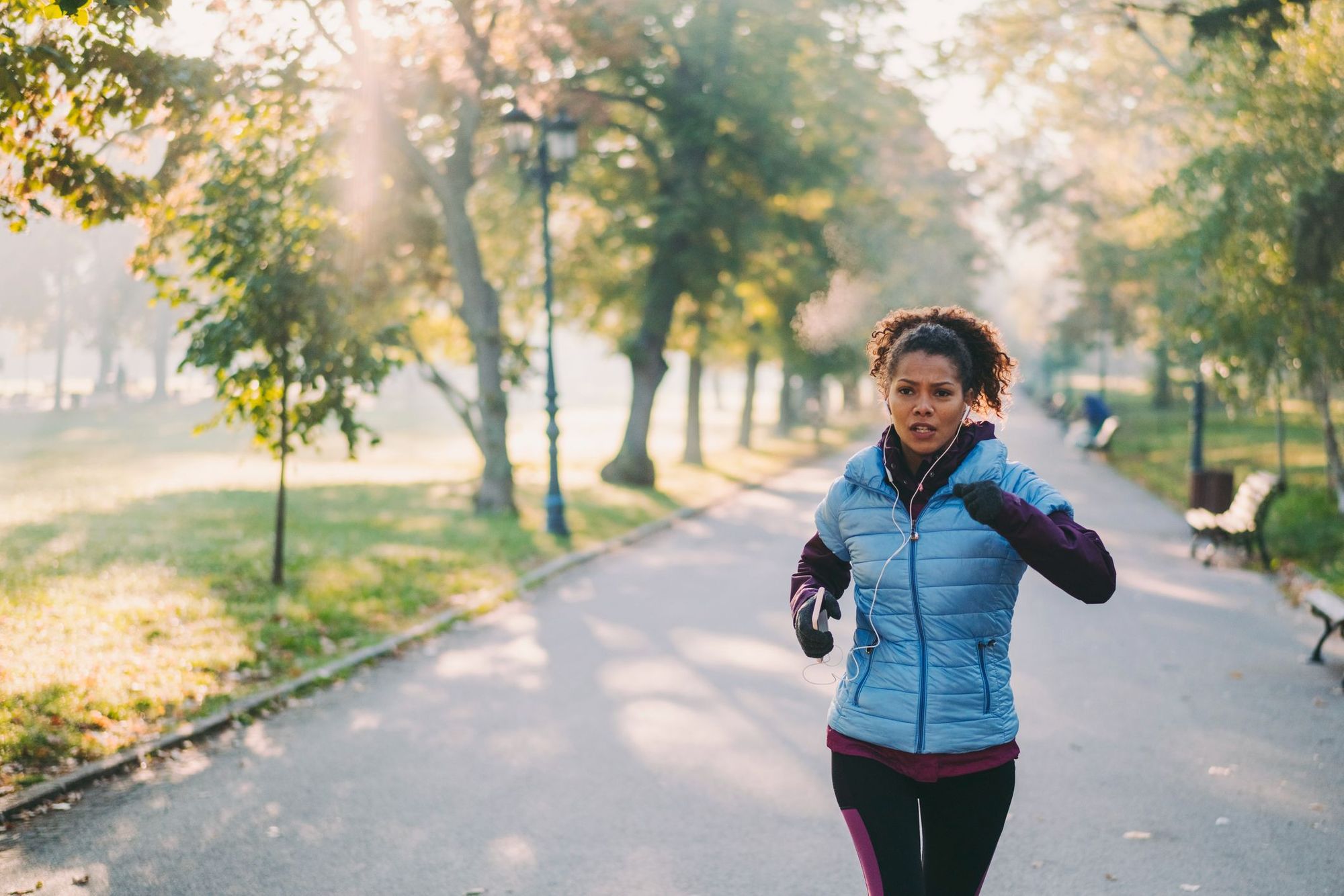 A woman running on an autumn day in the park