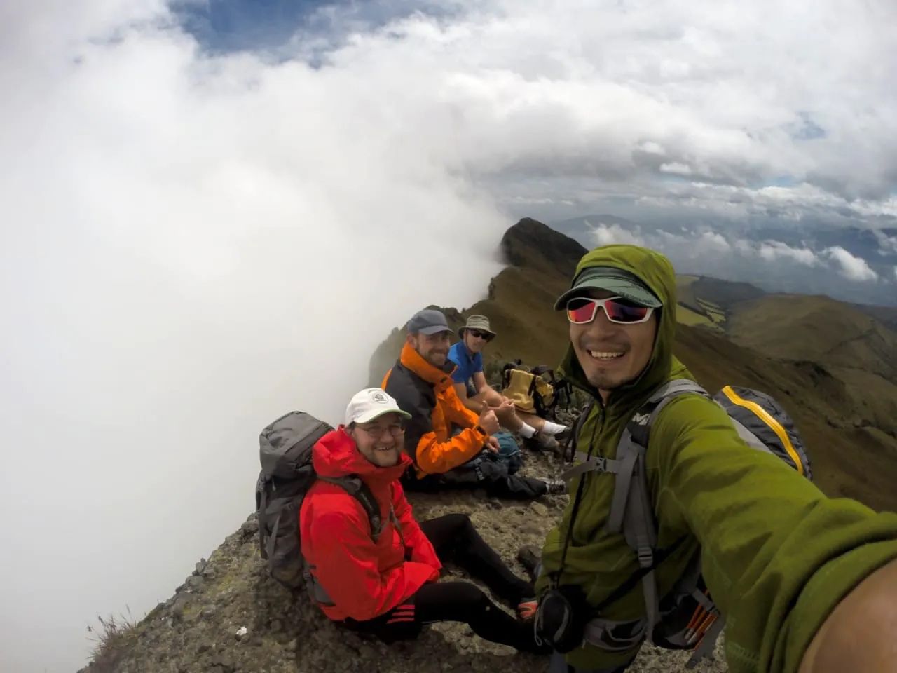 A hiking group poses at the top of Pasachoa Volcano in Ecuador