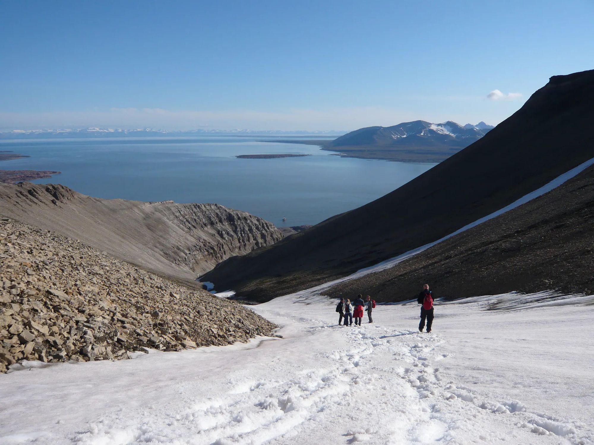 A group of hikers pauses for a break on the trail up Sarkofagen Mountain, on the island of Svalbard.
