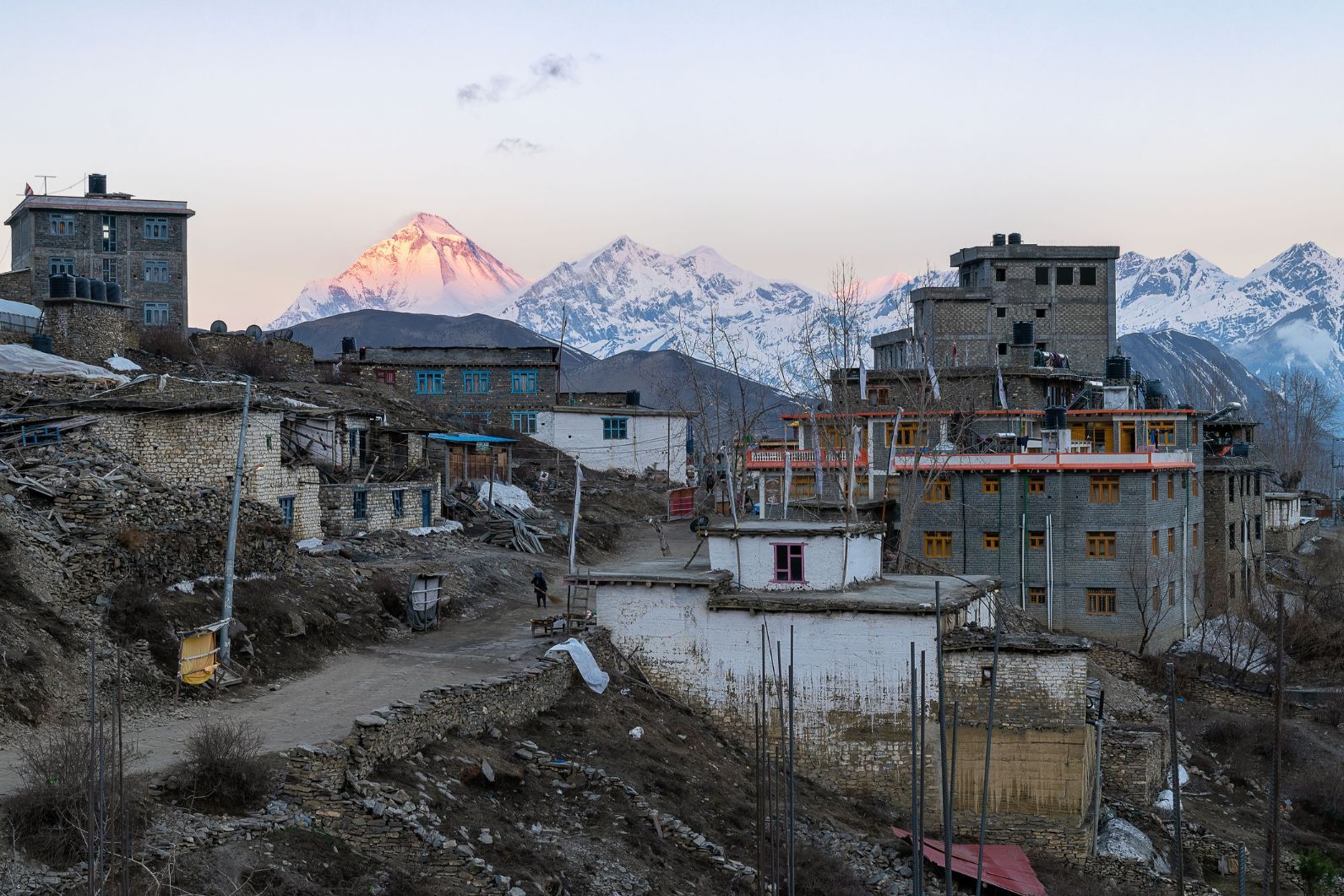 The buildings of Muktinath village and snowy peaks against dawn sky, on the Annapurna circuit, Nepal. Photo: Getty