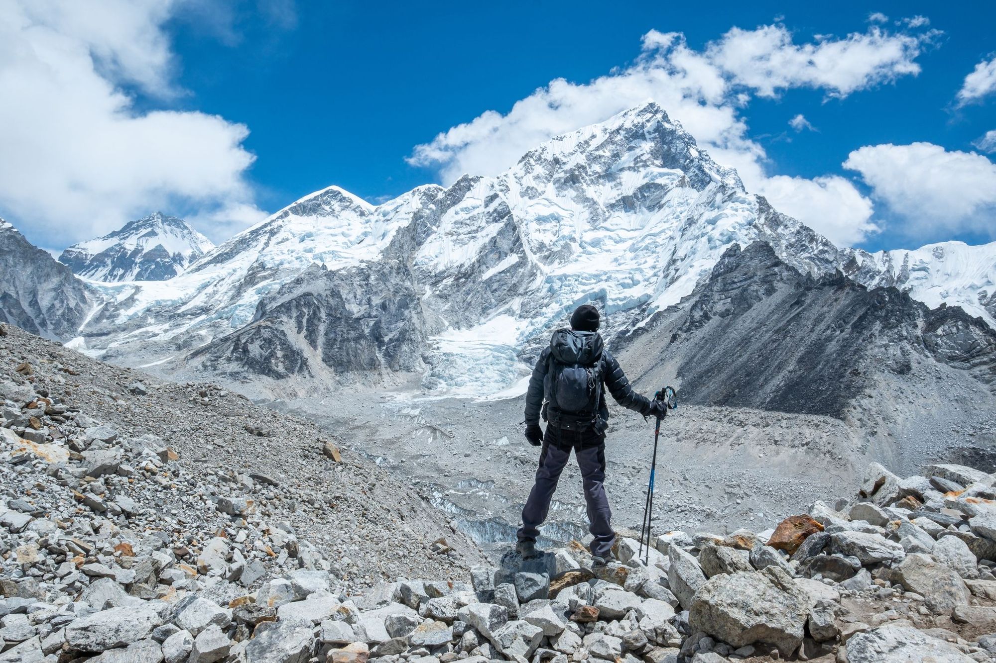 Male backpacker enjoying the view on mountain walk in Himalayas. Everest Base Camp trail route