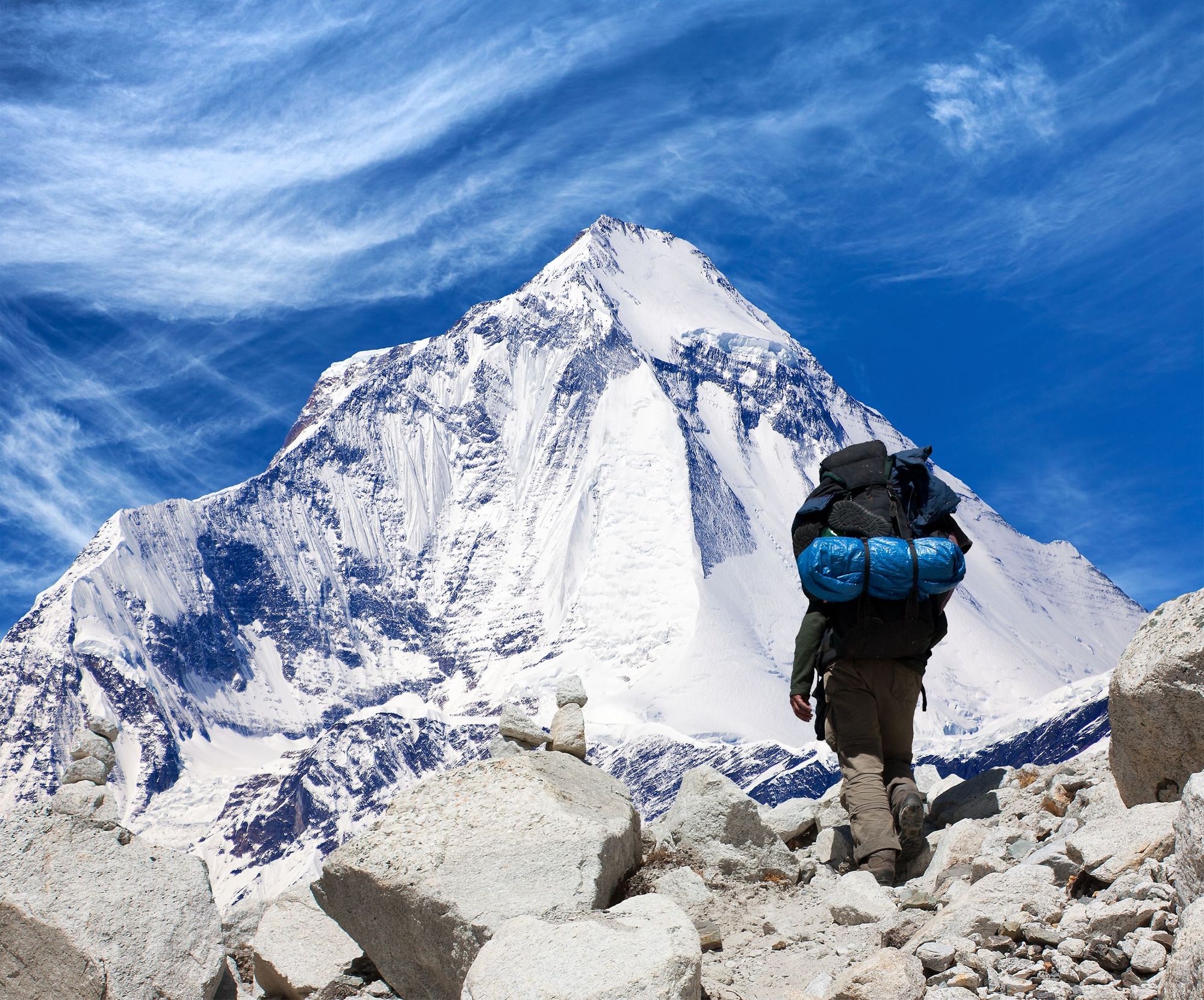A hiker with a heavy backpack in the Himalayas
