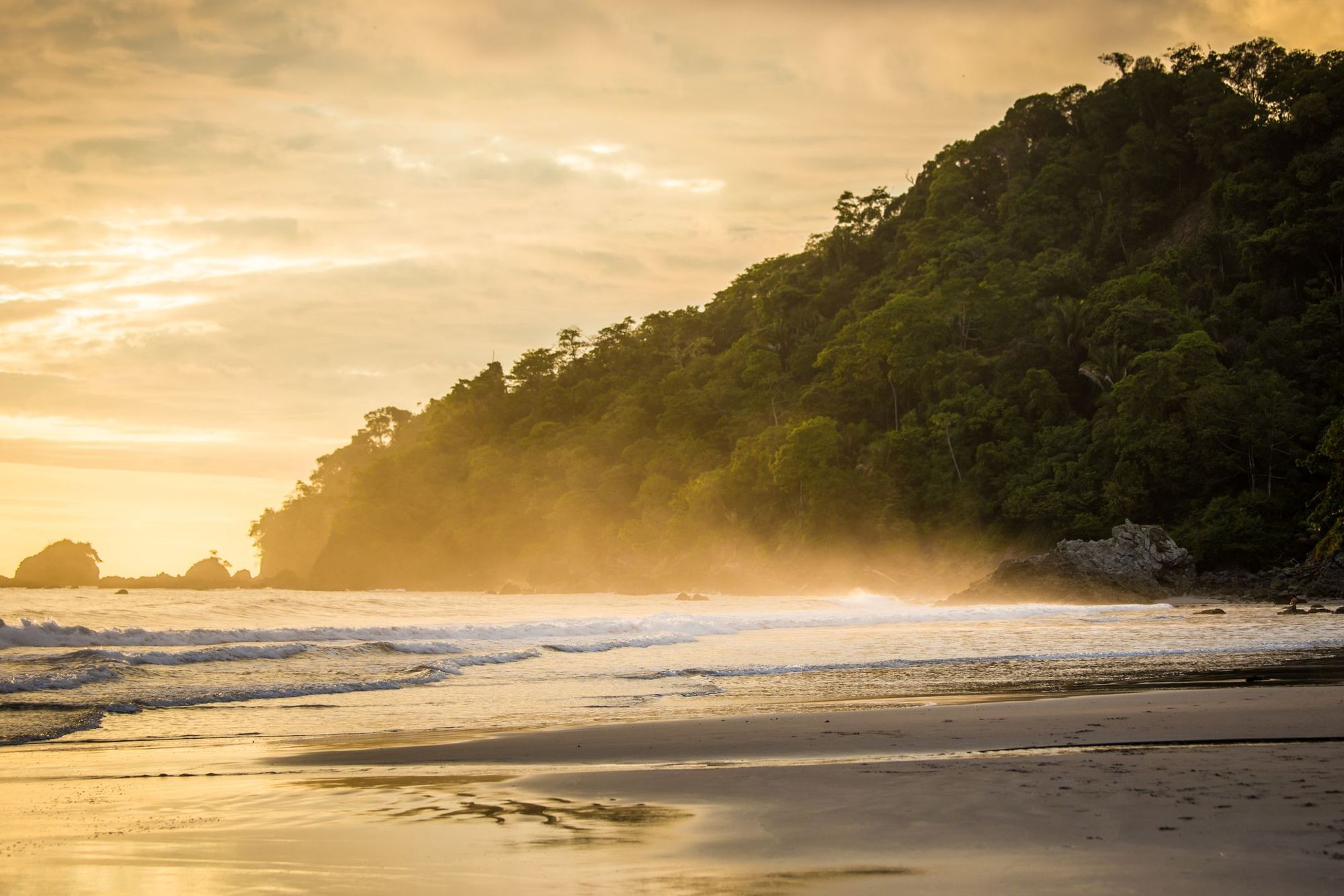 A deserted beach in Manuel Antonio National Park, Costa Rica, at sunset.
