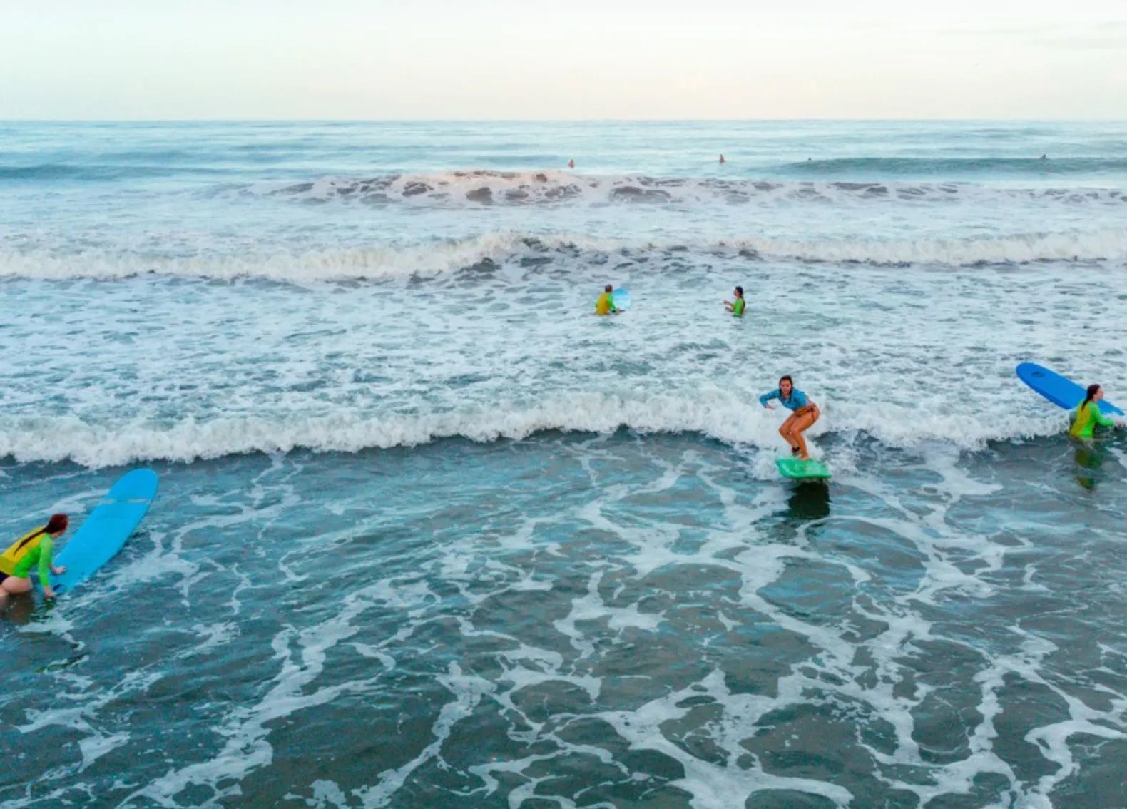 Surfers learning how to ride waves in Manzanillo.