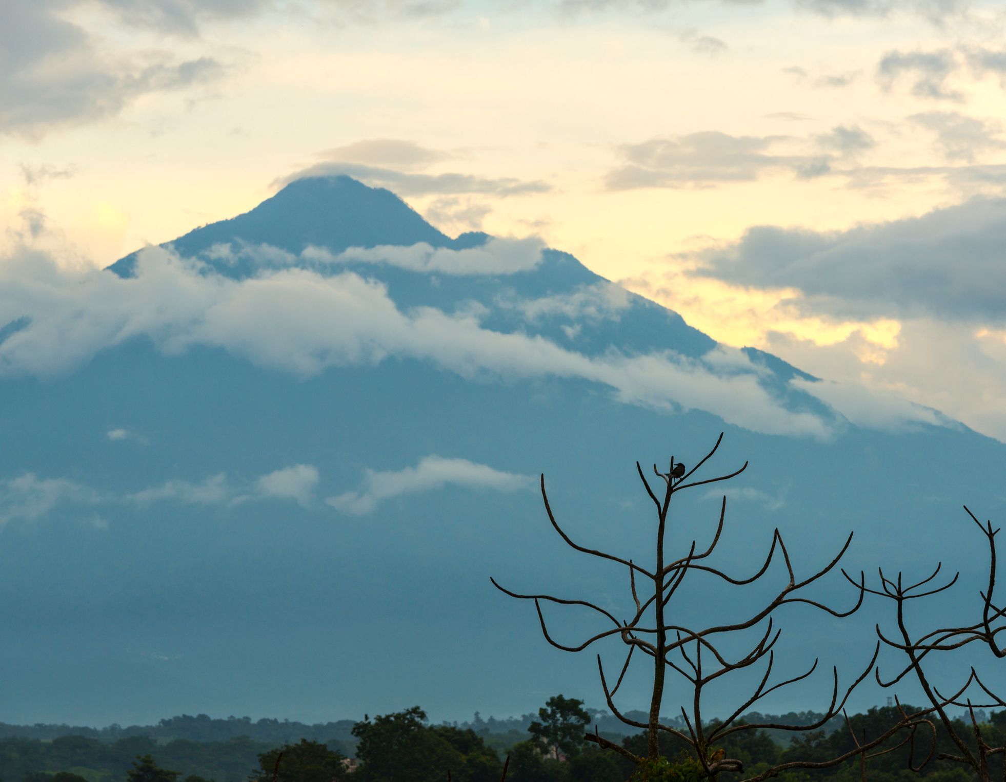 Mount Tajumulco, the highest point in Central America, seen at dawn surrounded by clouds. Photo: Getty.