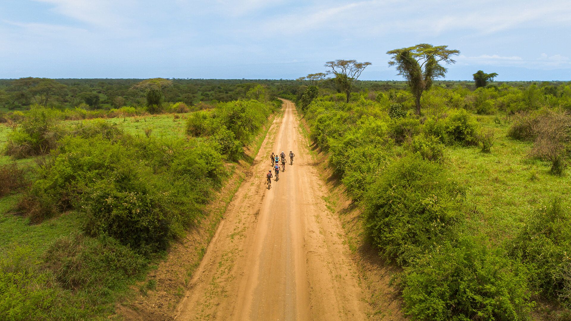 A group of cyclists head out into the savannah landscape near Lake Mburo, on the Uganda Cycling Trail. Photo: FatPigeon.cc