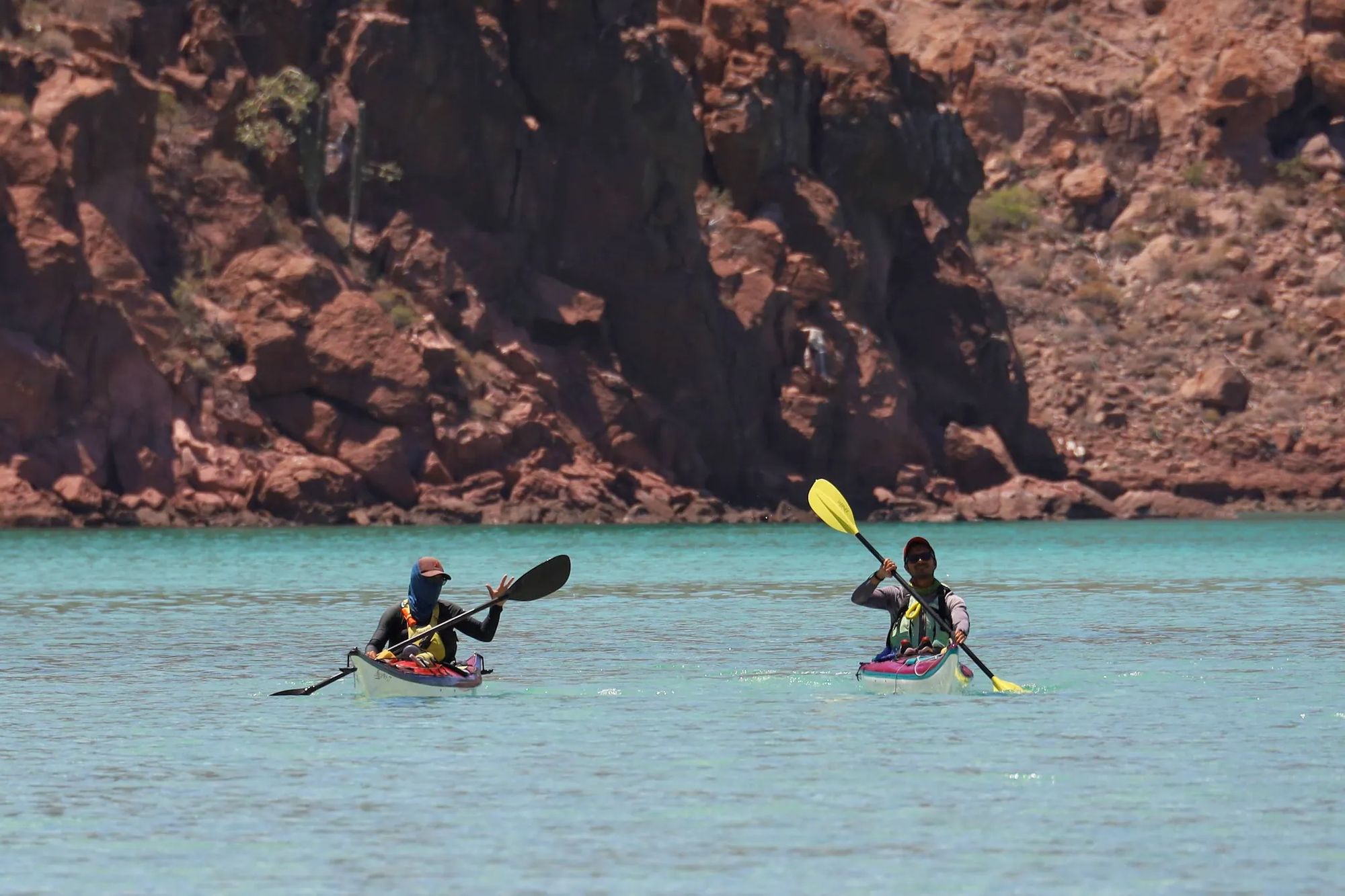 Two kayakers paddle in the waters around Isla Espiritu Santo, Mexico