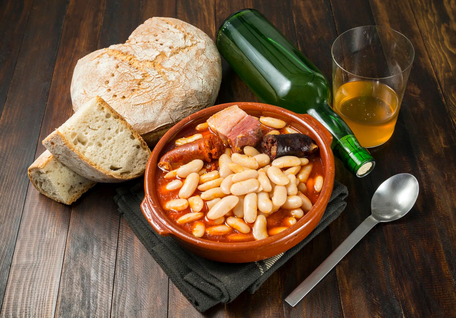 Traditional fabada stew, served with crusty bread and Asturian cider.