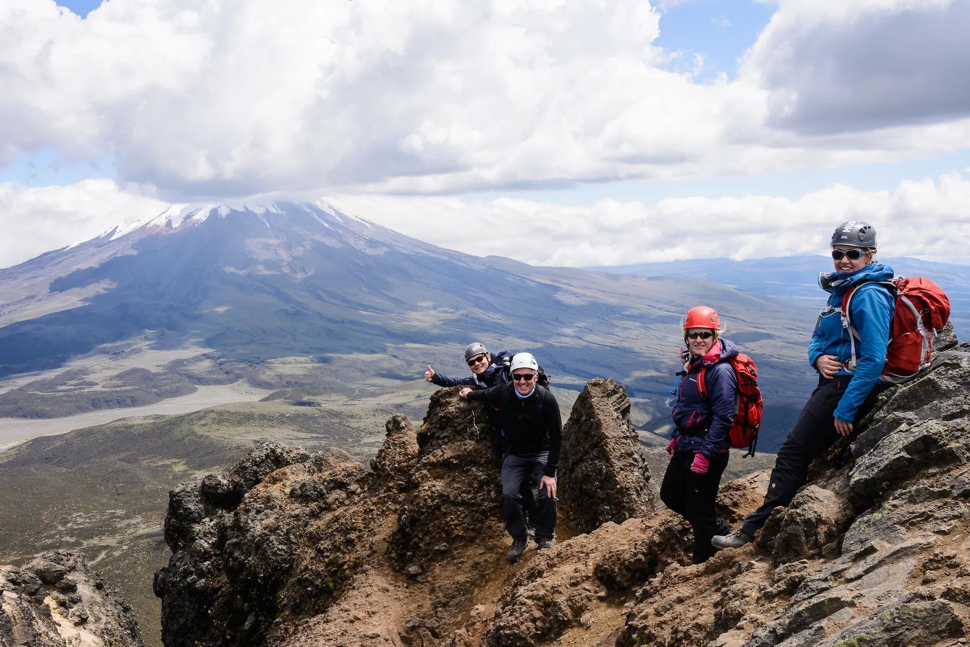 Hikers pose on top of Rumiñahui, in Ecuador