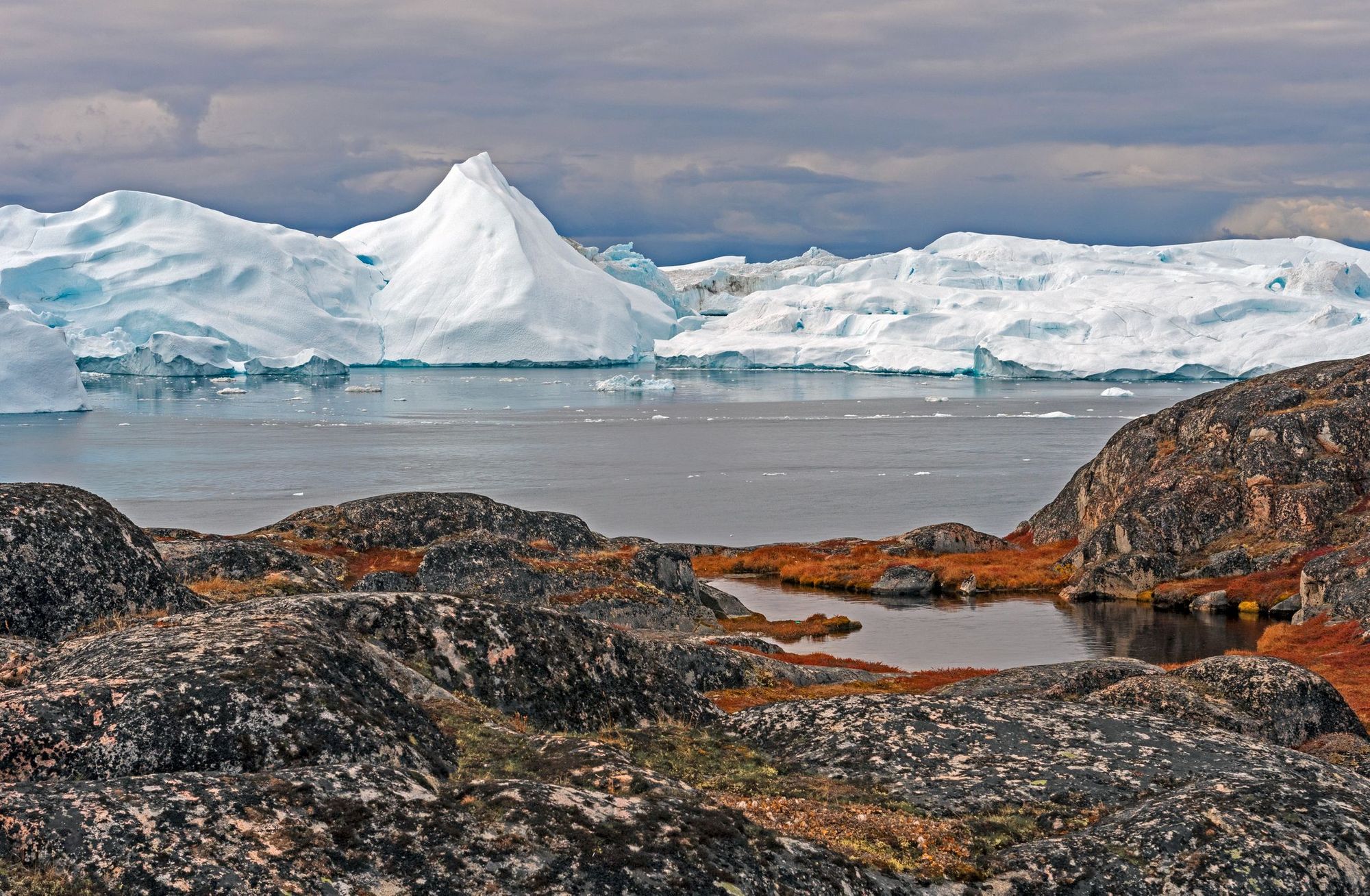 the northernmost arctic, with glaciers backdropping a rock.