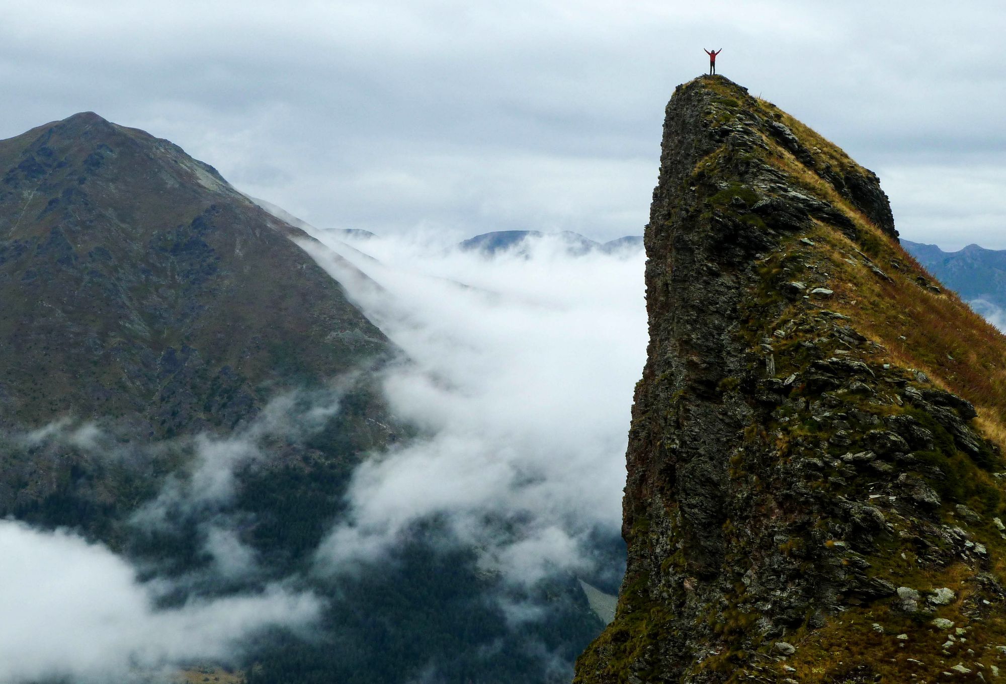 Hiker with arms wide open on Mount Gjeravica in the Accursed Mountains, Albania