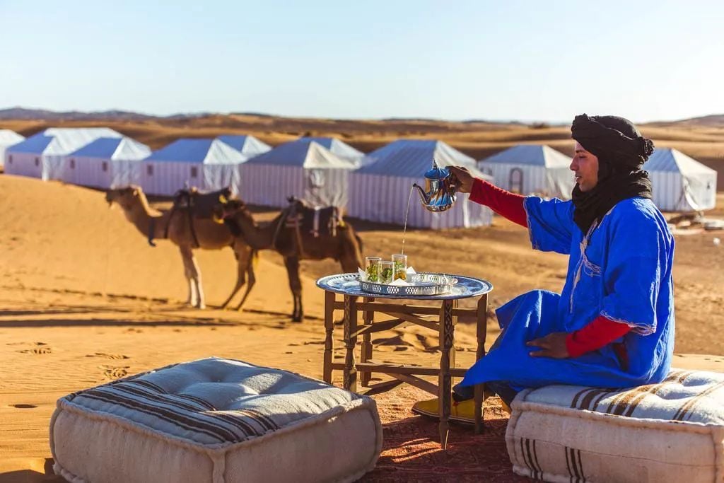 A man pours mint tea at a Berber camp in Morocco's Sahara Desert.