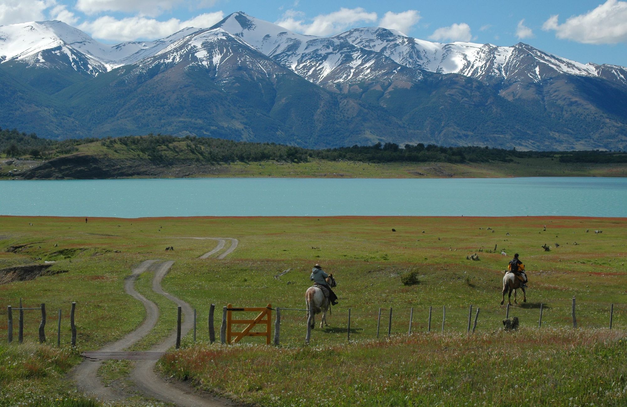 Horseback riders in Argentina, with the Andes mountains behind.