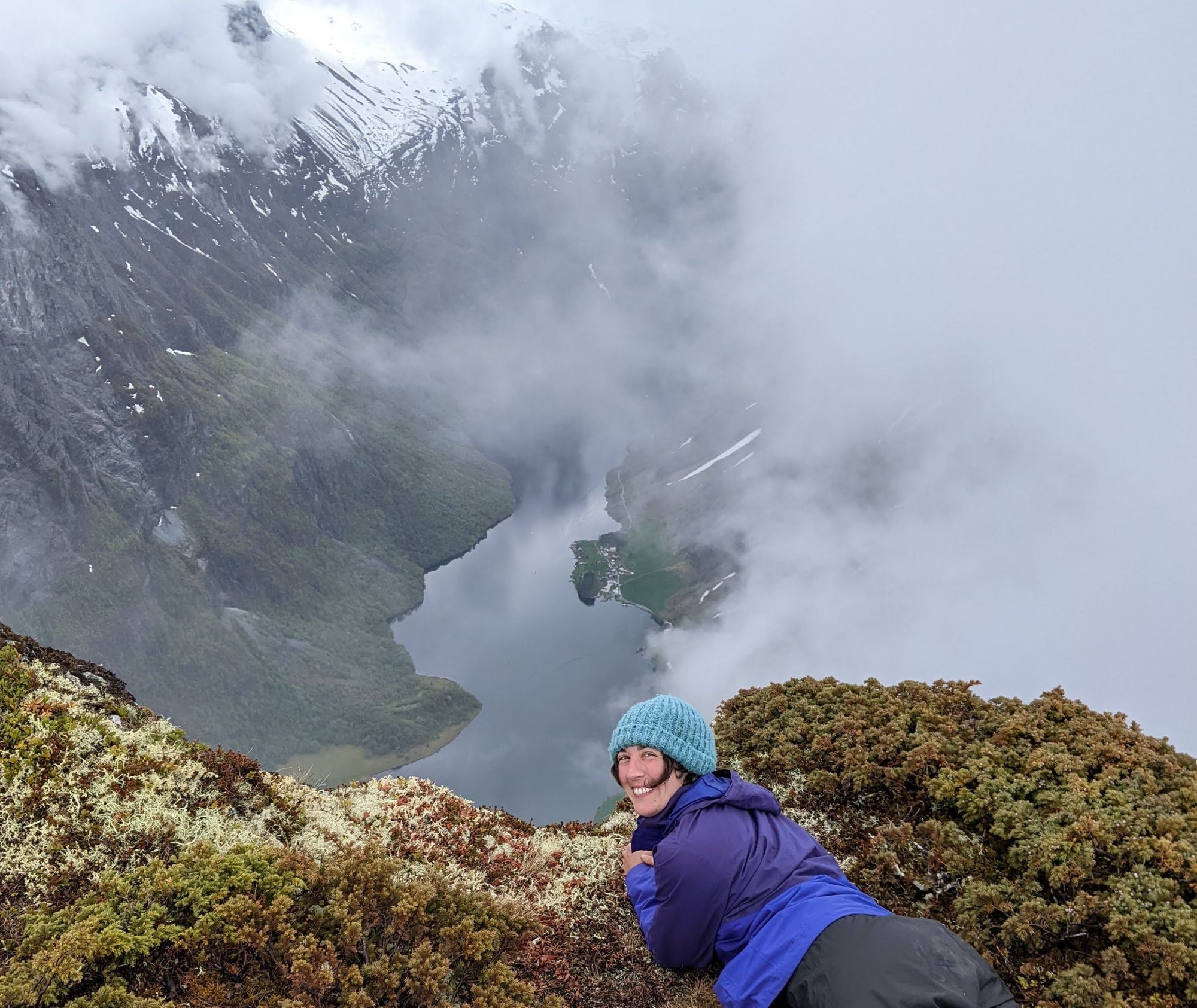 A hiker posing at the top of the Norwegian Fjords.