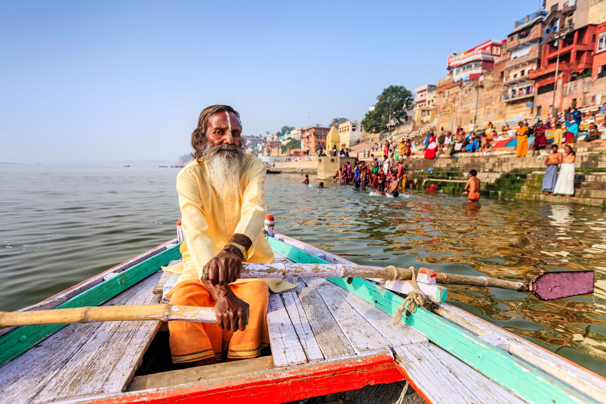 A sadhu, or Indian holy man, rowing across the Ganges in Varanasi.