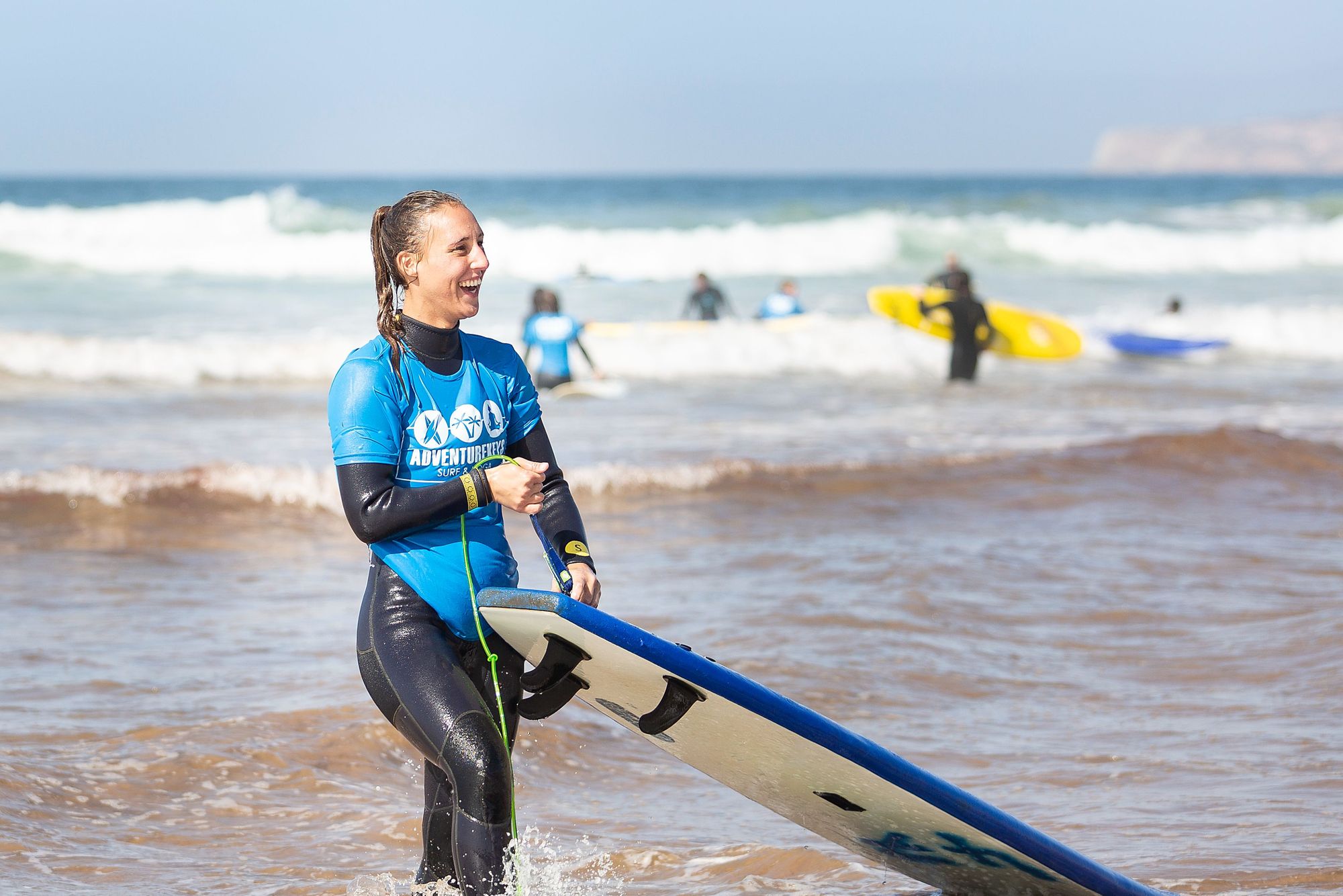 A female surfer emerging from the waves in Taghazout Bay, Morocco