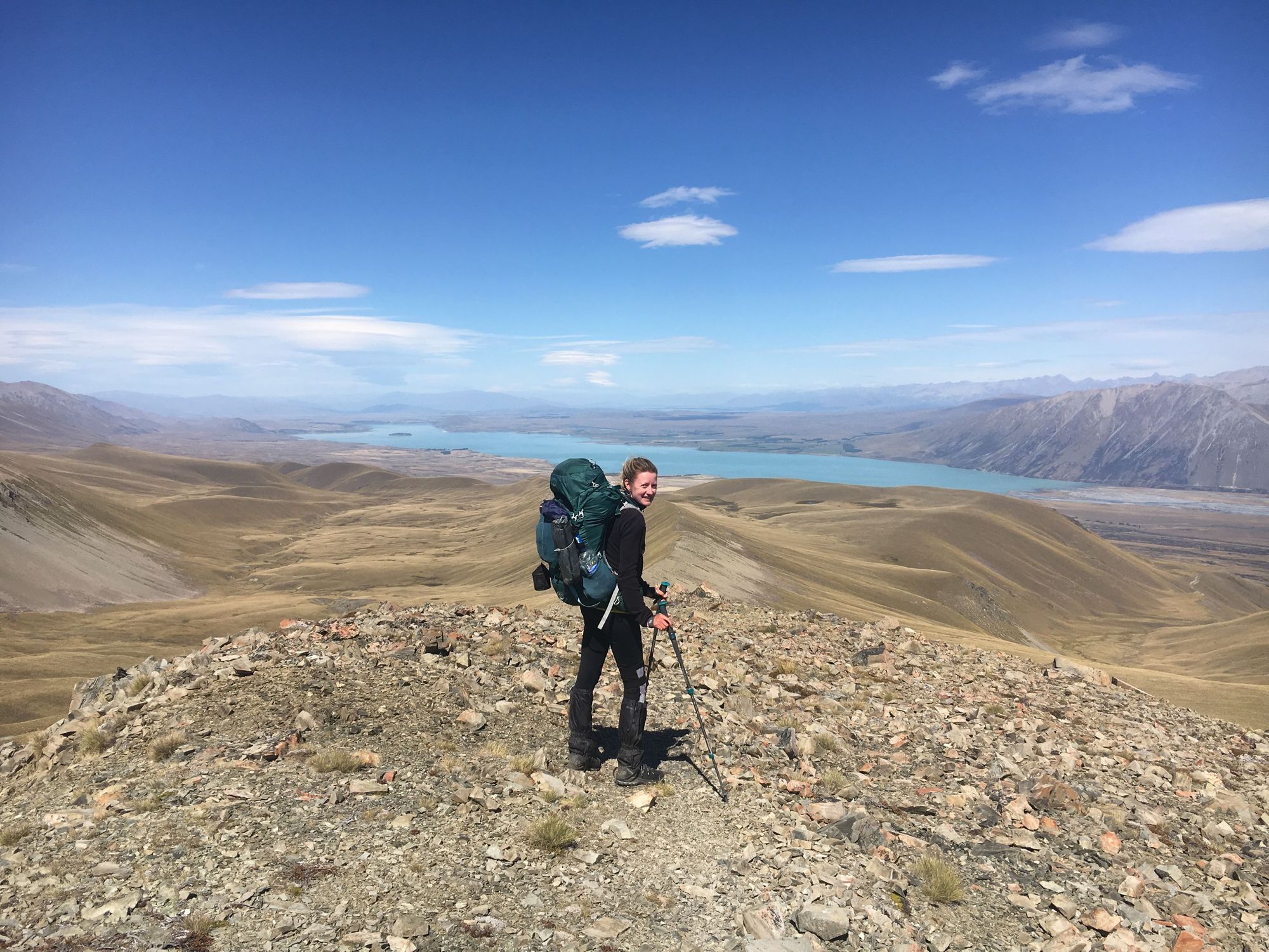 A hiker poses near Lake Tekapo, New Zealand's south island.