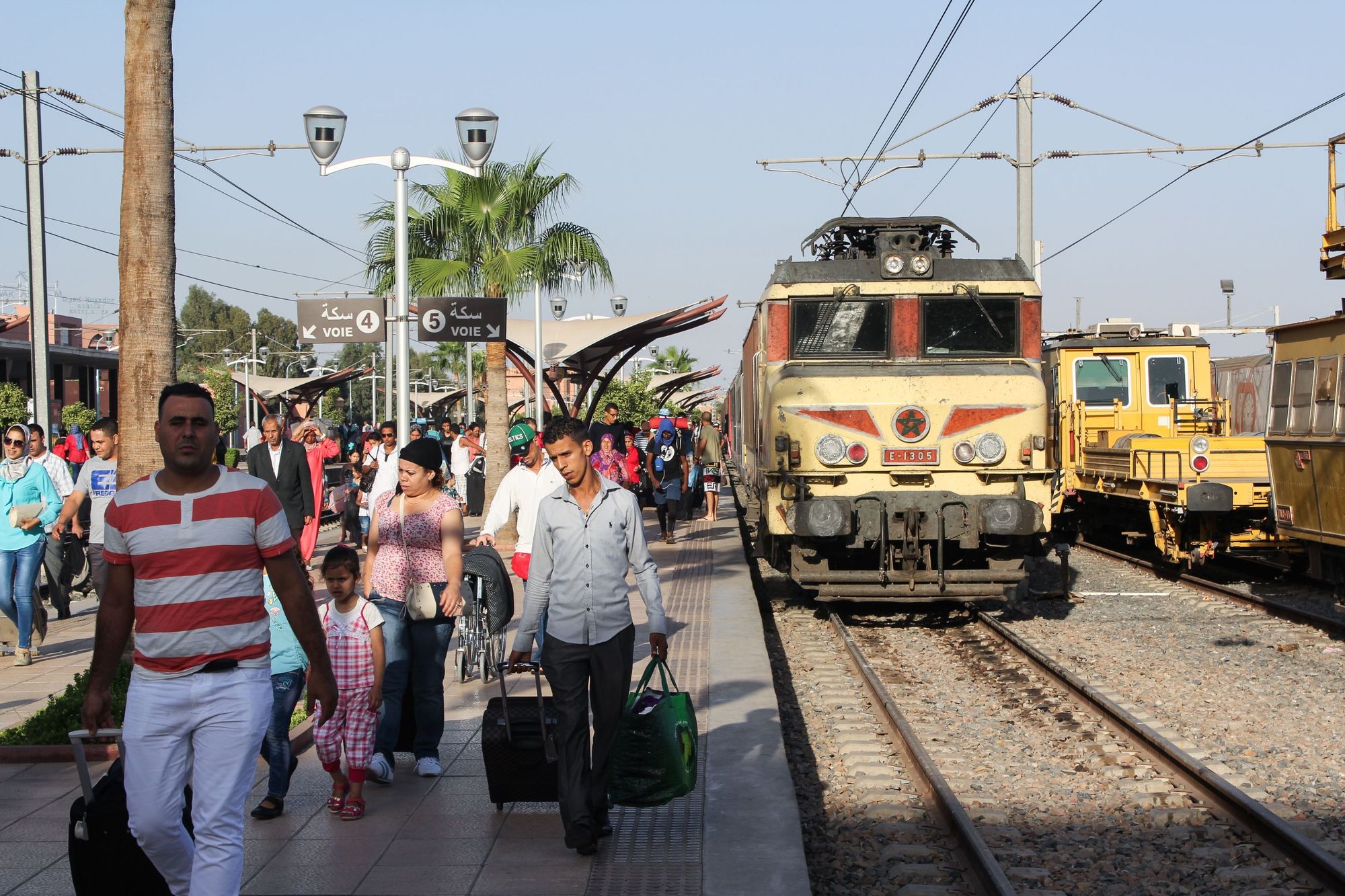 Crowds on the platform of Marrakech's bustling railway station.