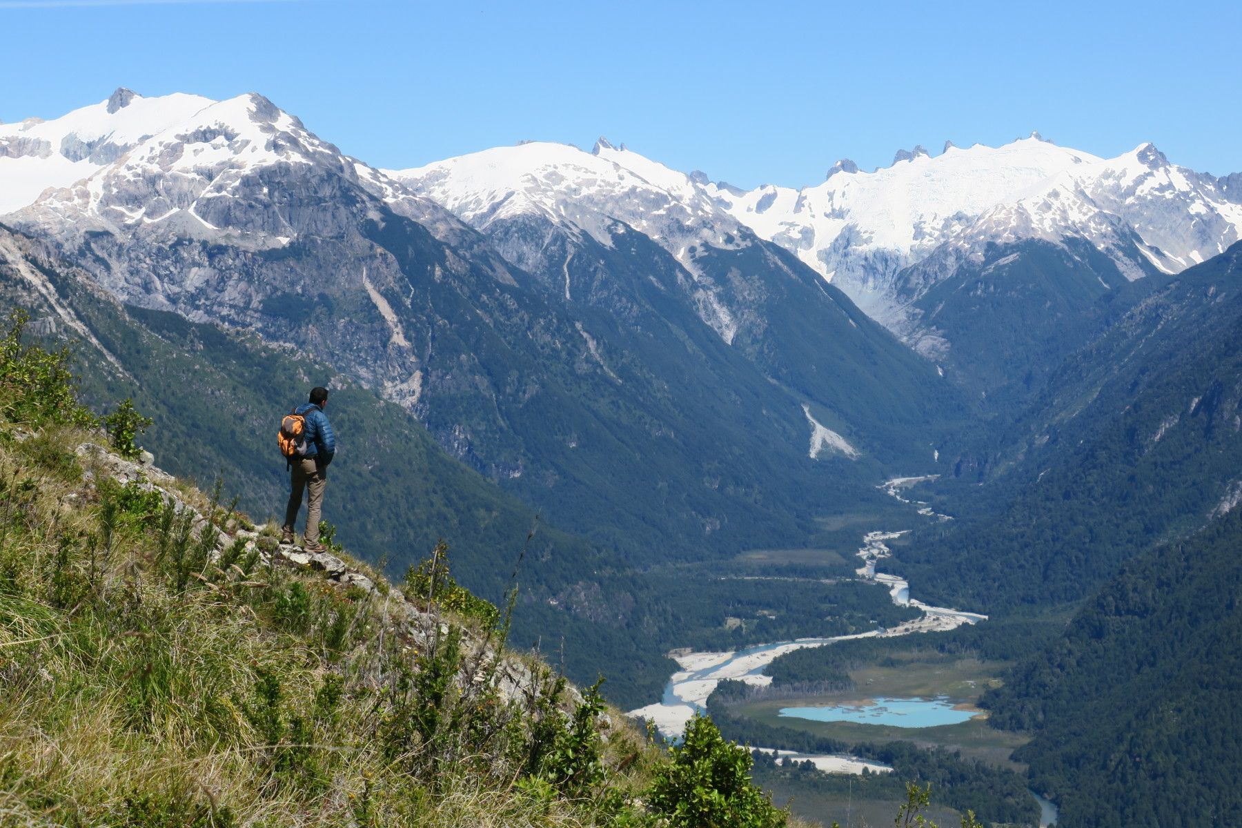 A man stares out across the hills and mountains of Chilean Patagonia.