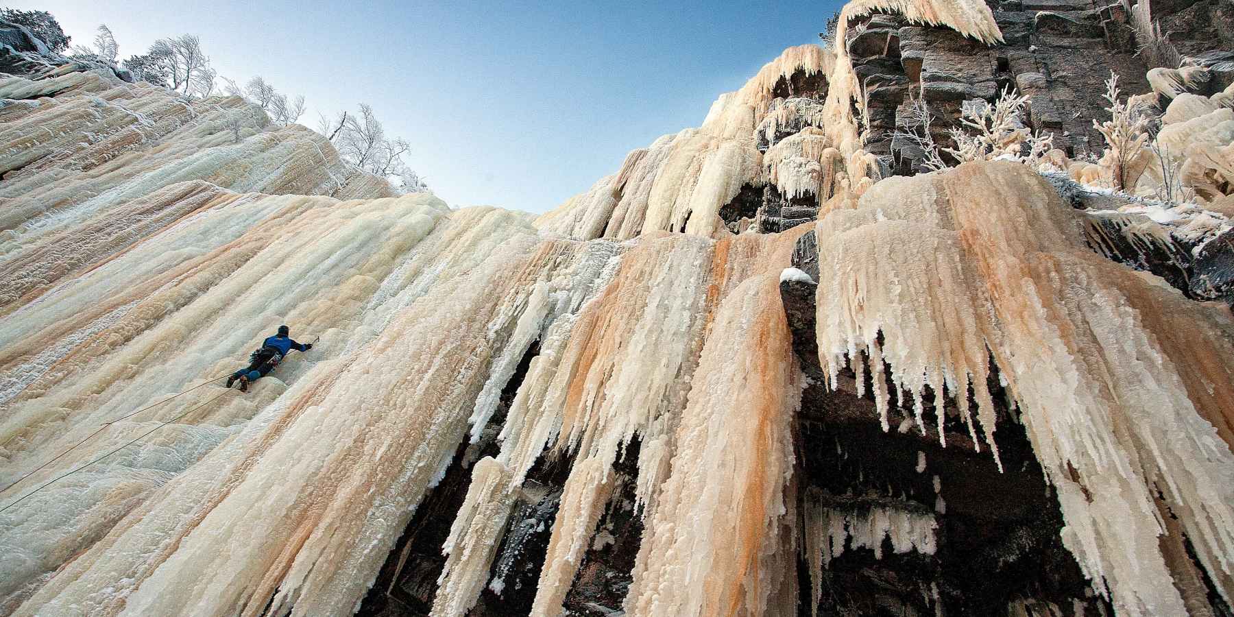 A man climbs a frozen waterfall in Finland's Korouma Canyon.
