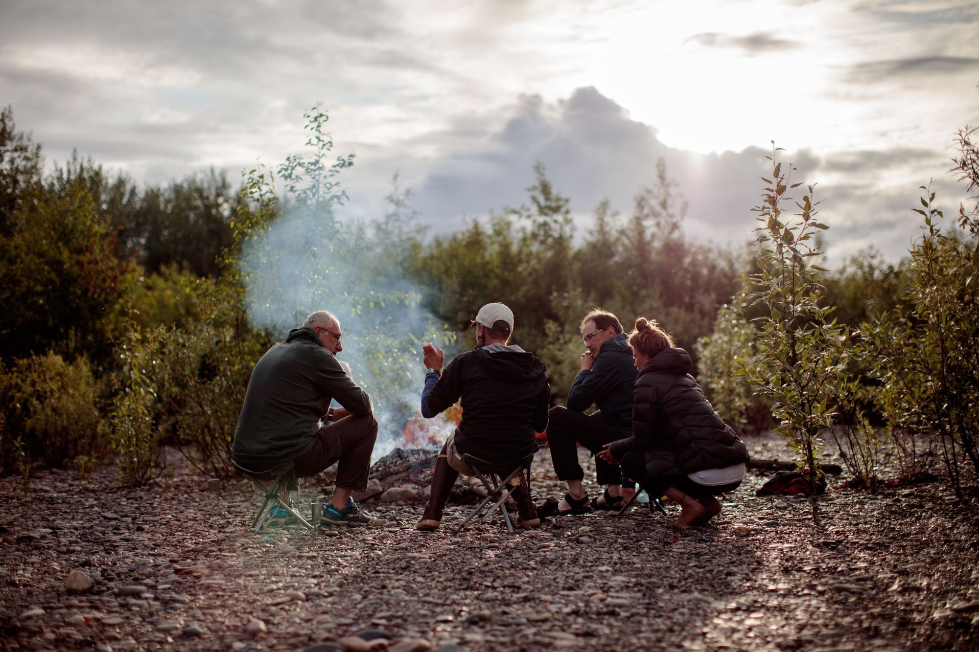 A group of people by the campfire in the Yukon, Canada