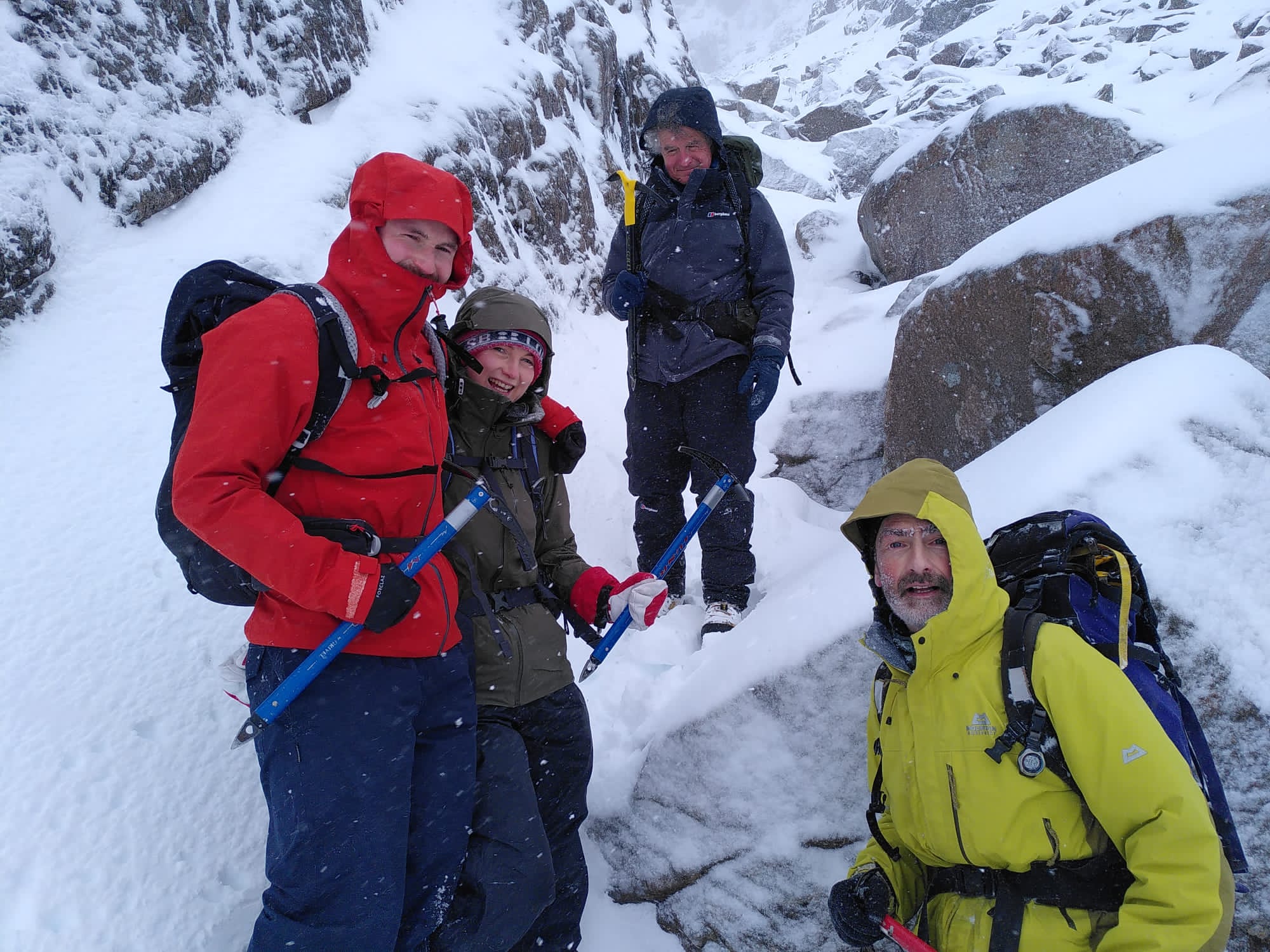 A group of mountaineers poses in the snow.