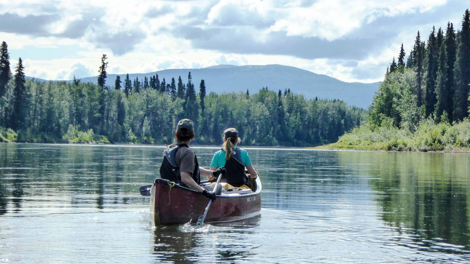 A couple in a double canoe on the Yukon River