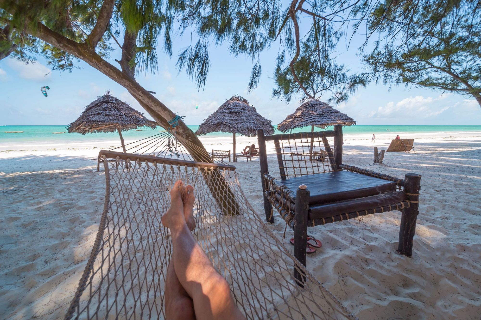 A tourist relaxes on a beach in Zanzibar.