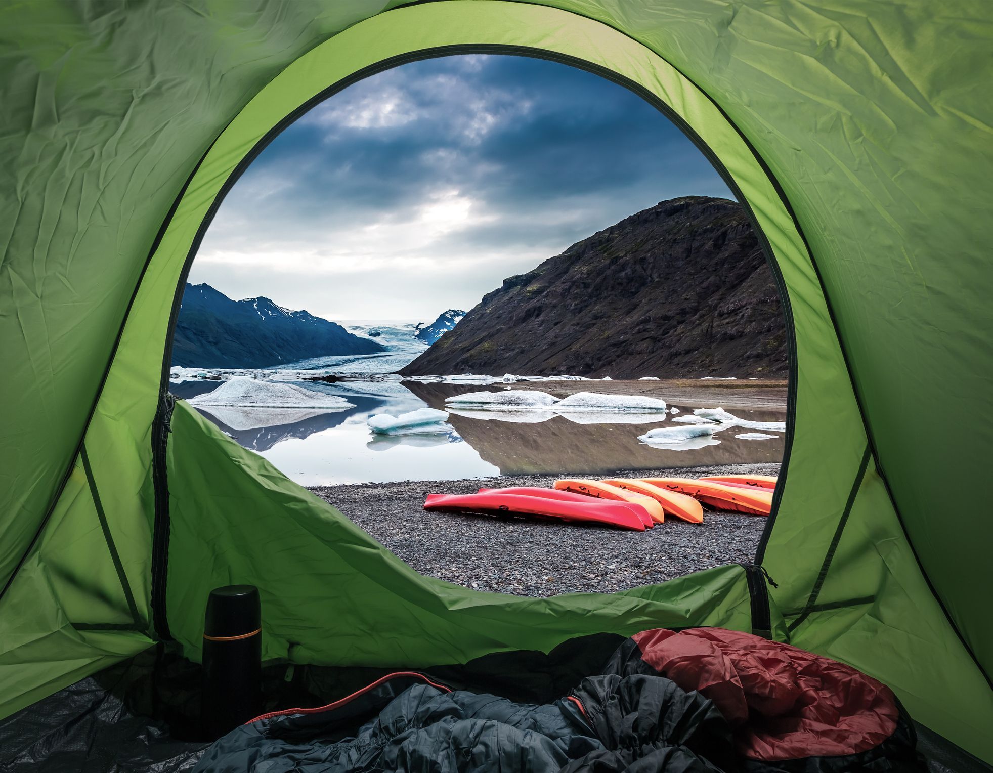 A glacial lake pictured in the Arctic, with kayaks layed out, ready for the day ahead. Photo: Getty